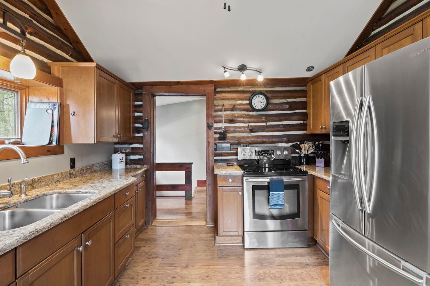 Kitchen with stainless appliances and wood cabinetry