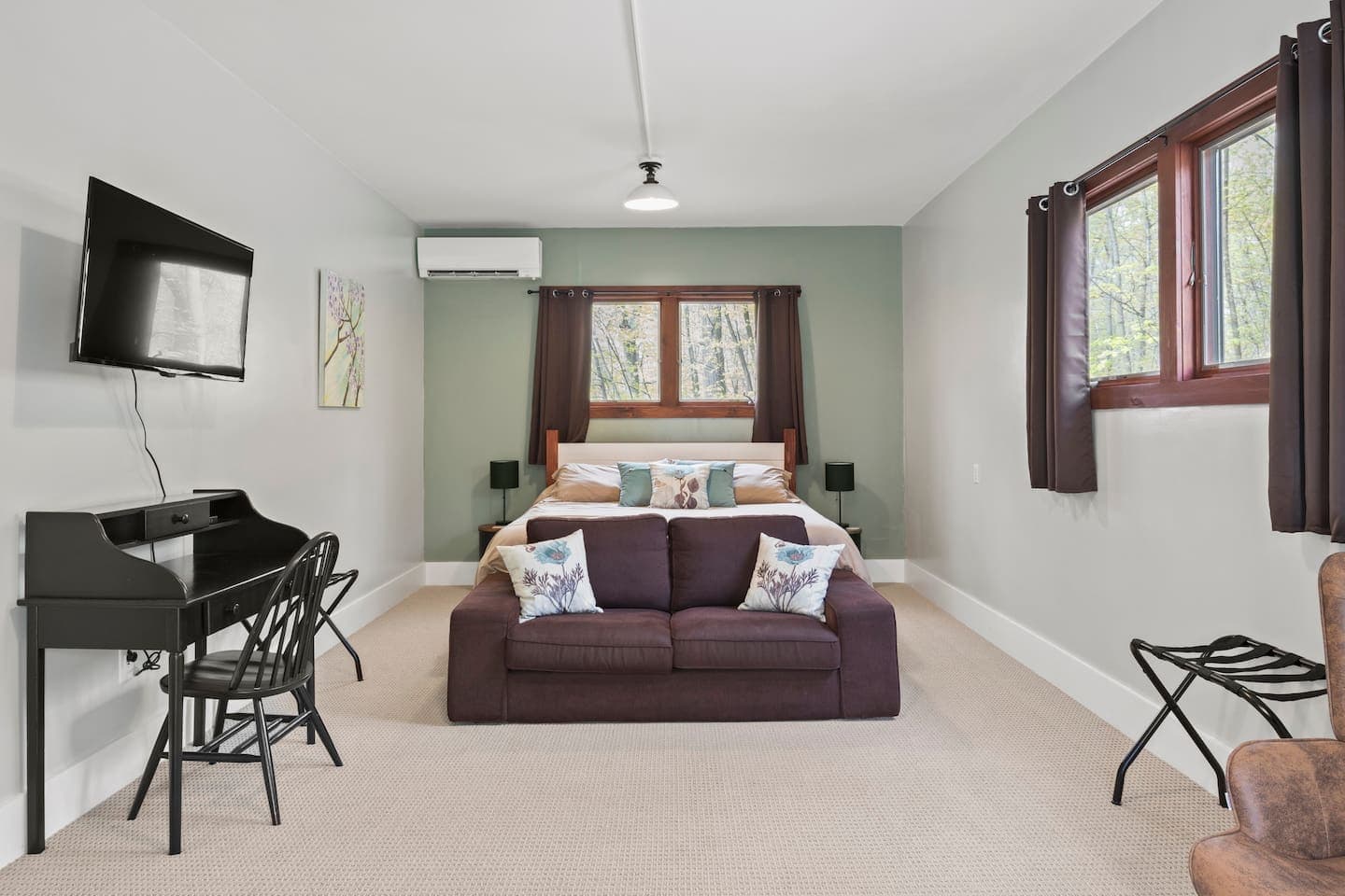 King bedroom with workspace and mounted television