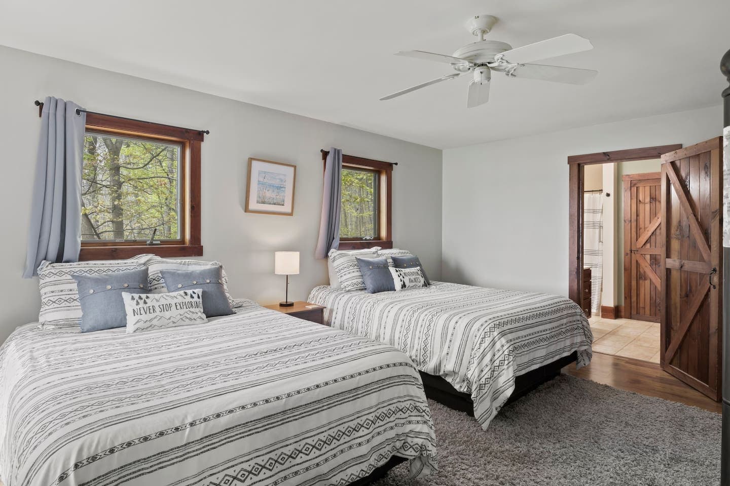 Bedroom with two beds and multiple windows