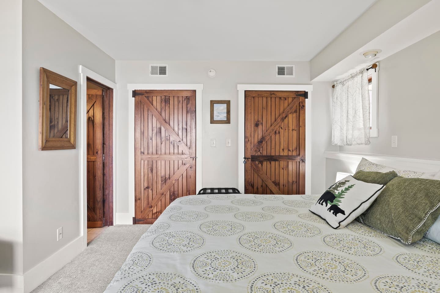 King bedroom with rustic barn doors