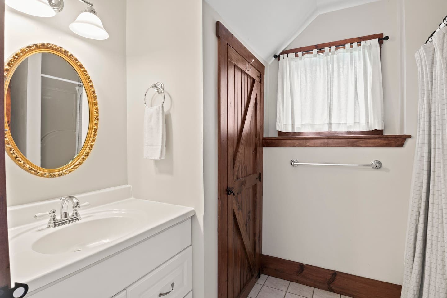 En-suite bathroom with shower and round mirror