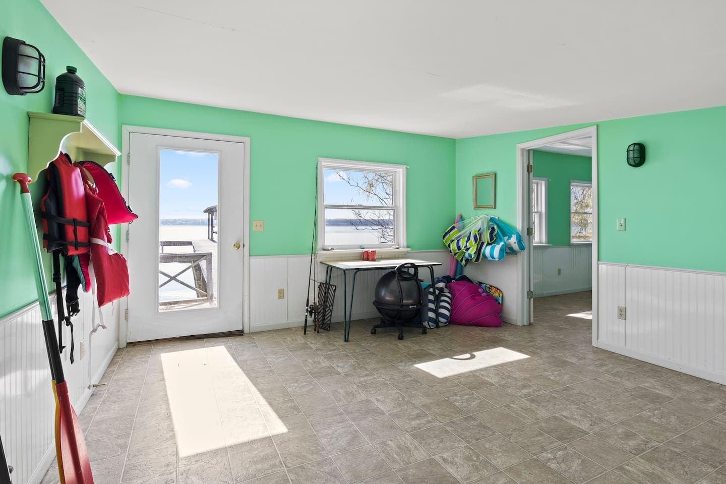 Boathouse interior with console table and life jackets
