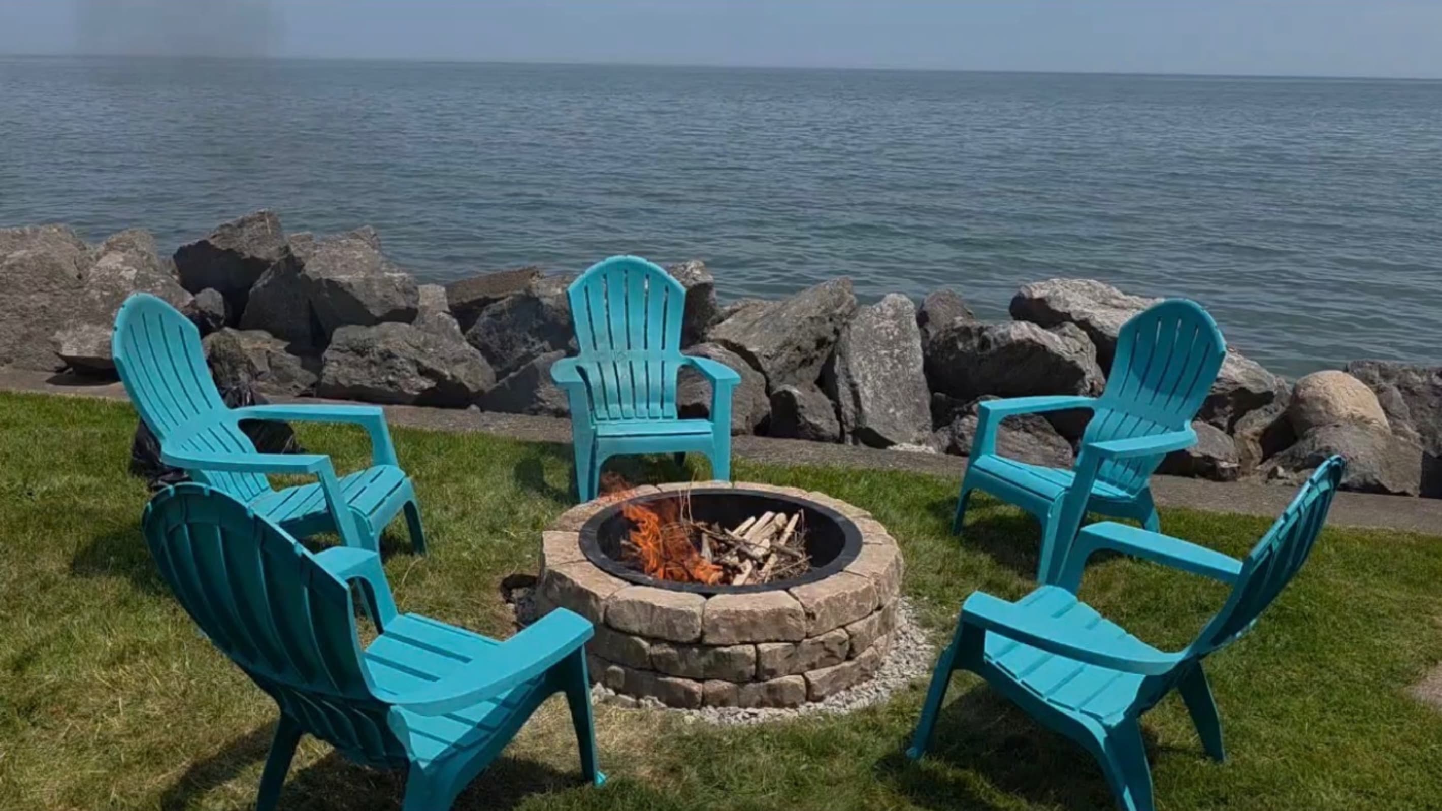 Lakeside fire pit with turquoise chairs