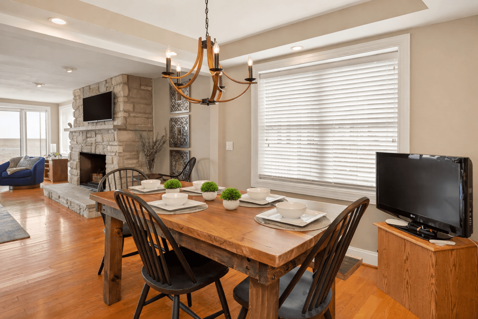 Dining table beside the stone fireplace