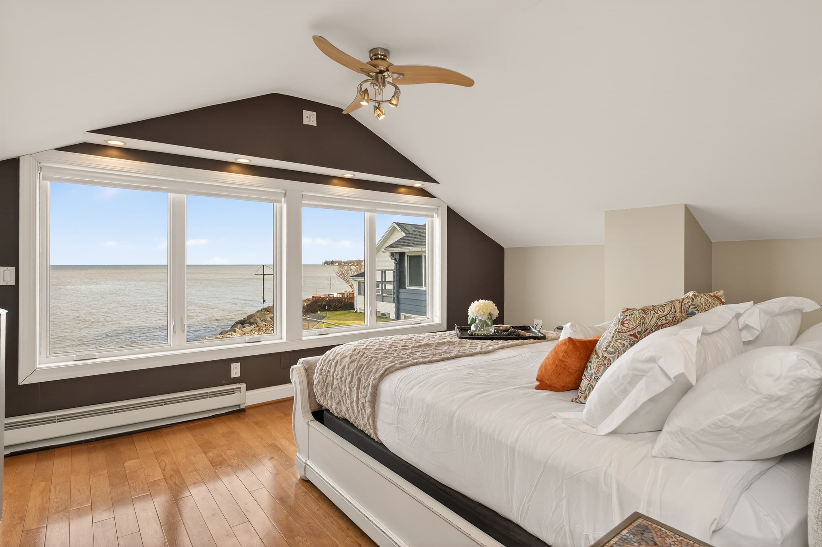 Bedroom with ceiling fan and wide windows