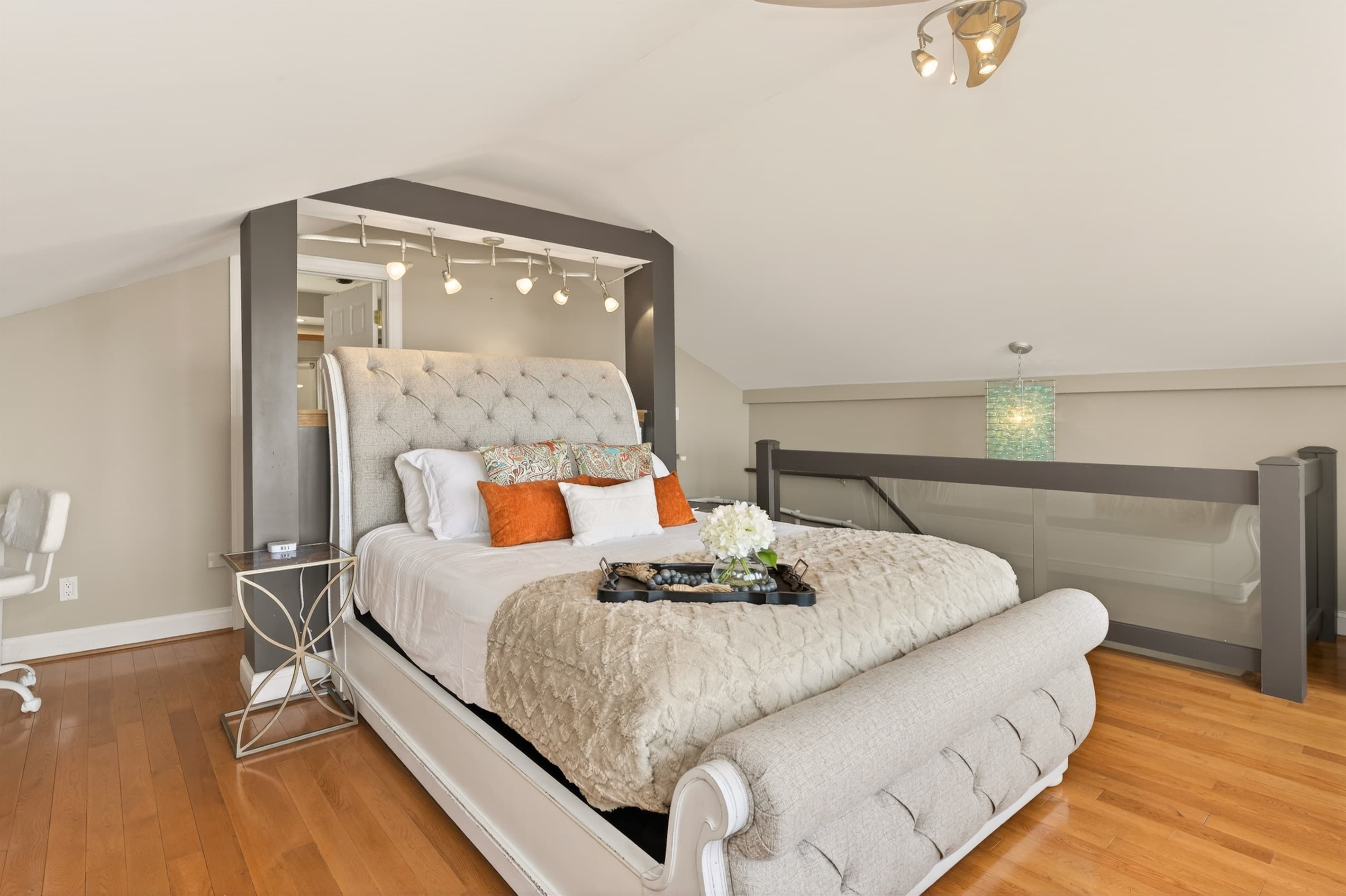 Bed positioned beside the open stair railing