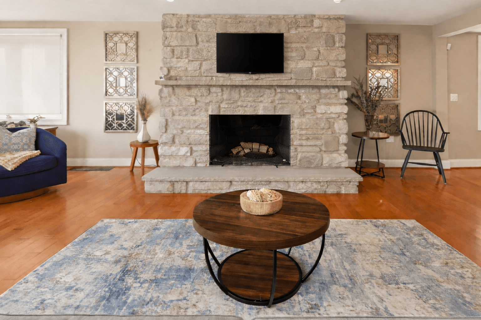Stone fireplace with television mounted above