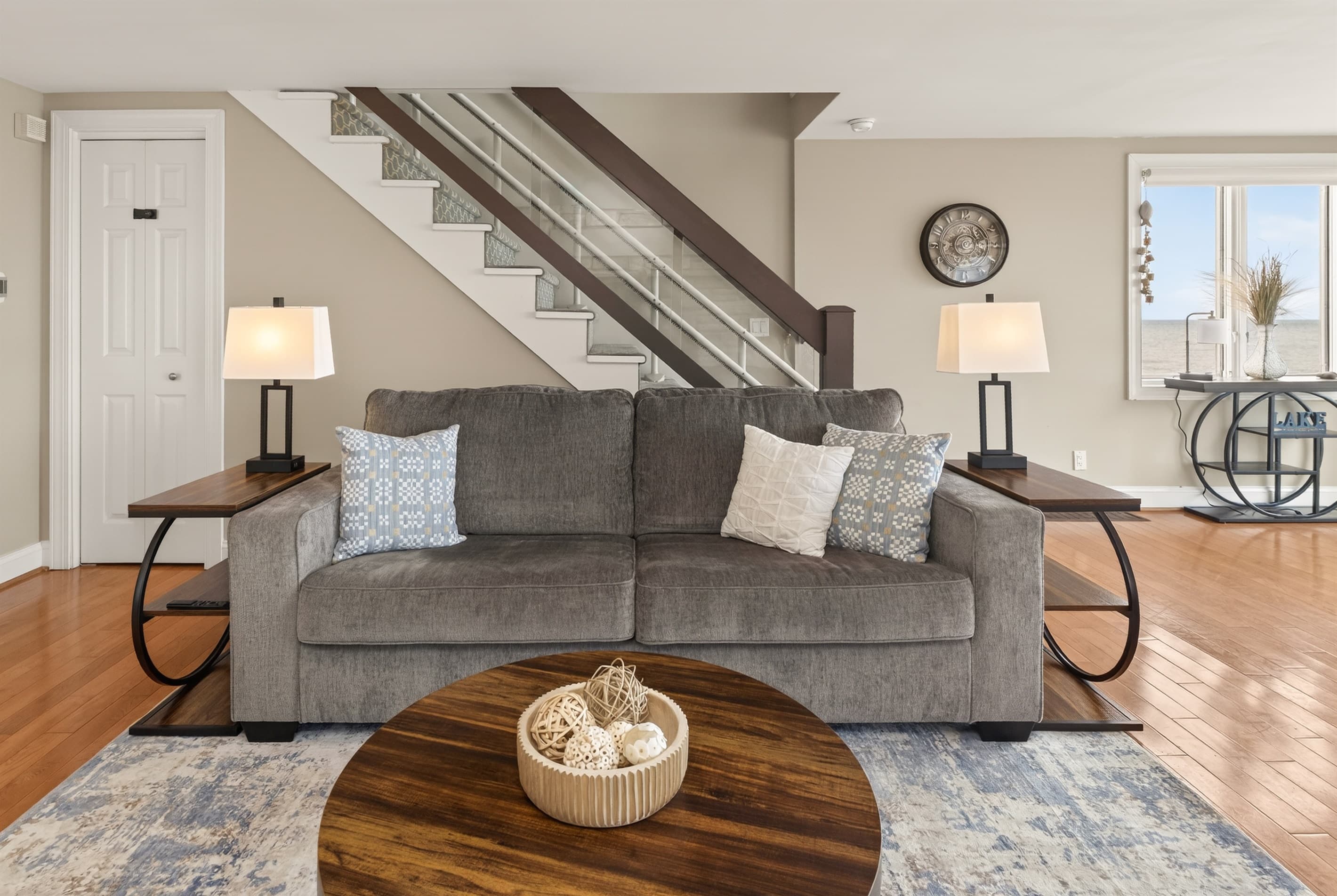 Sofa positioned beneath the staircase