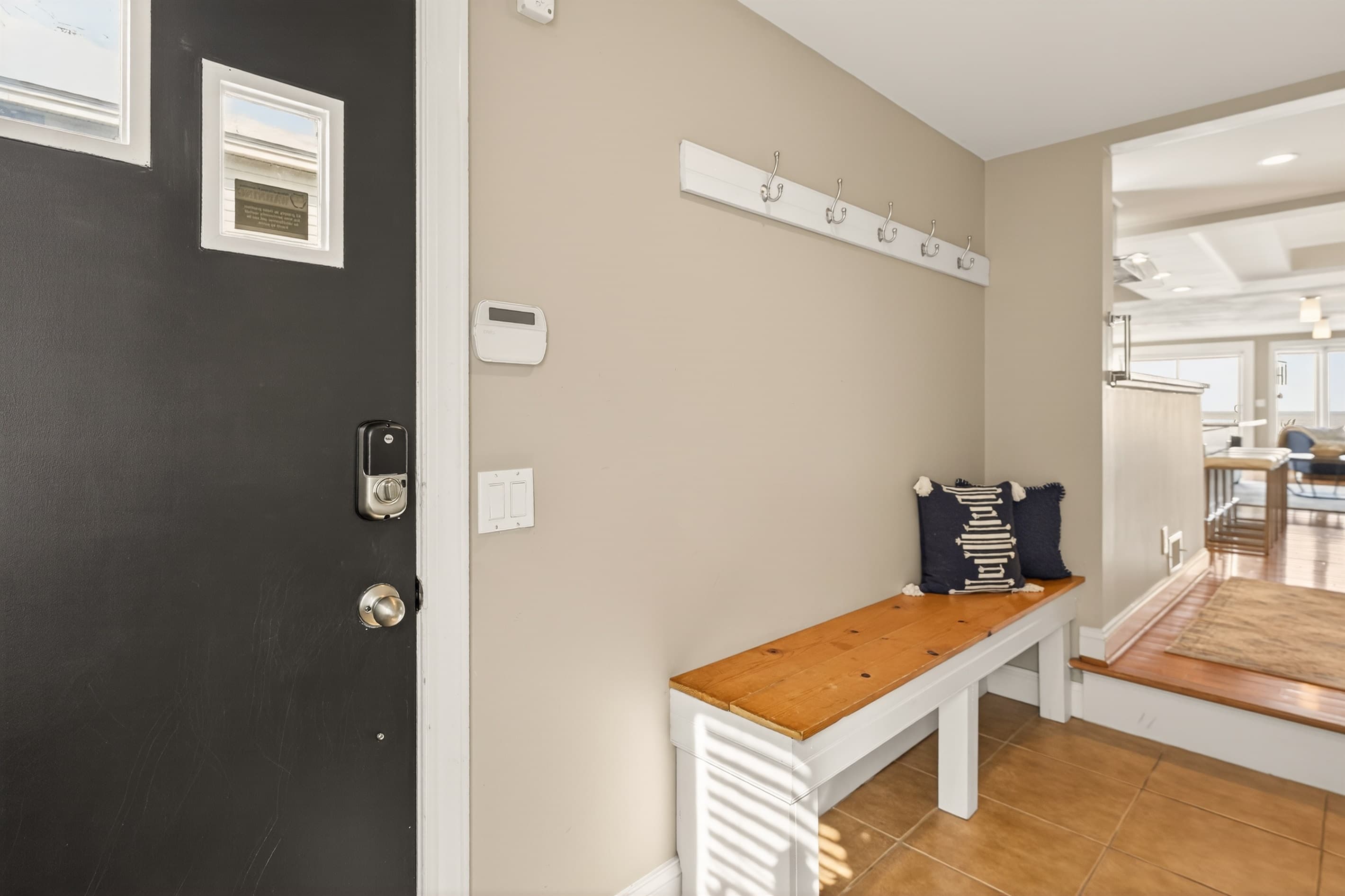 Entry bench beneath wall hooks