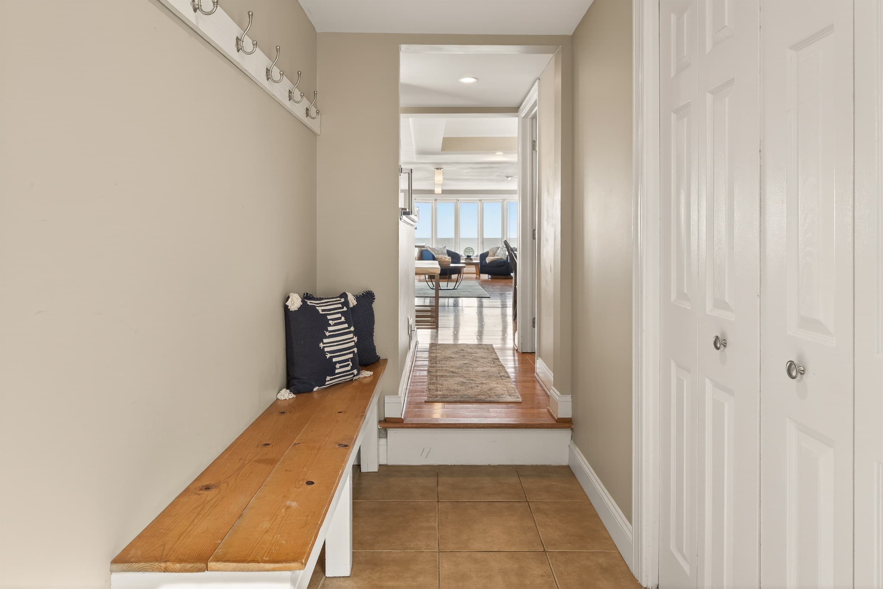 Wooden hallway bench between closet doors