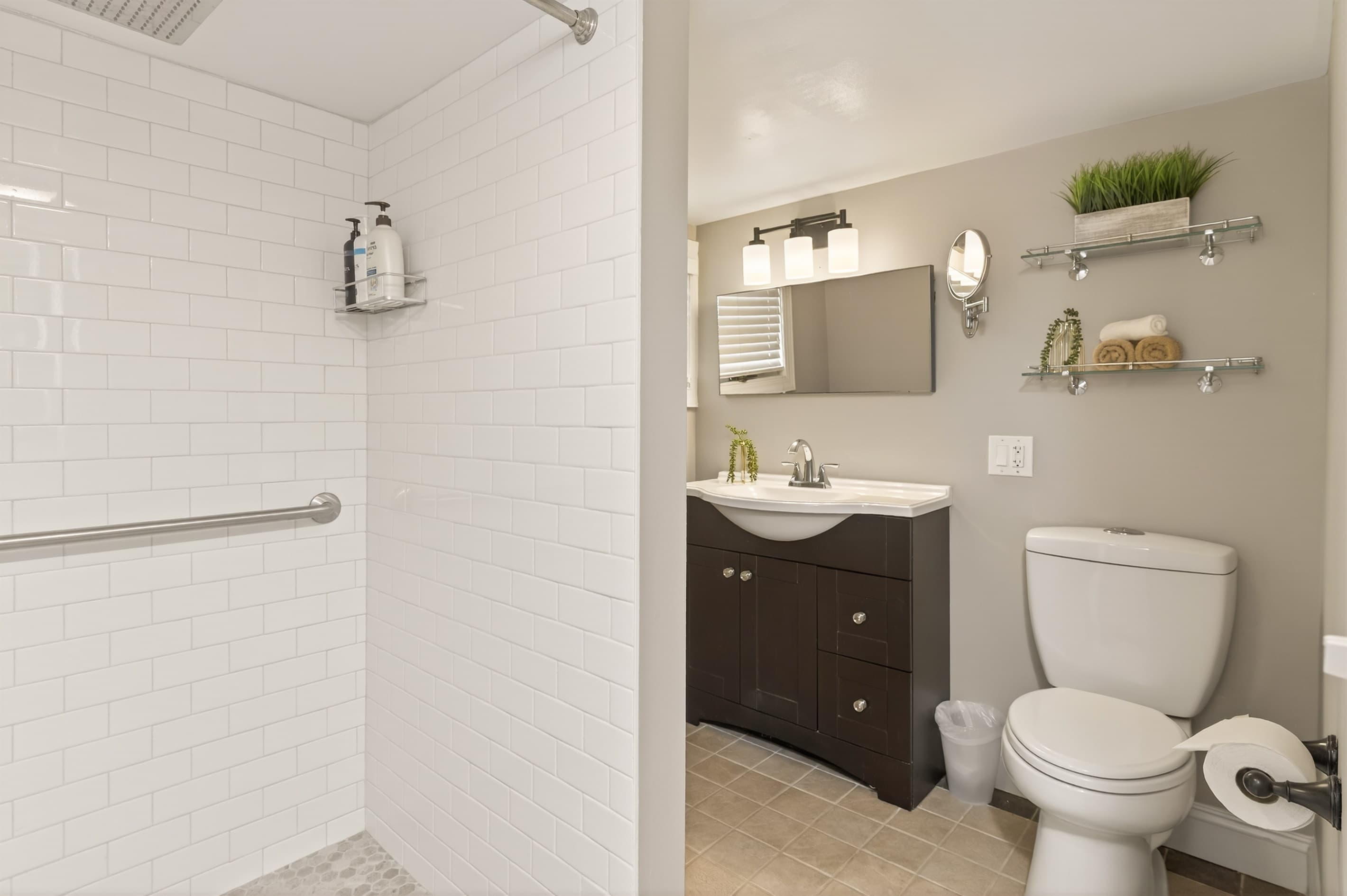 Bathroom with toilet, vanity, and grab bar