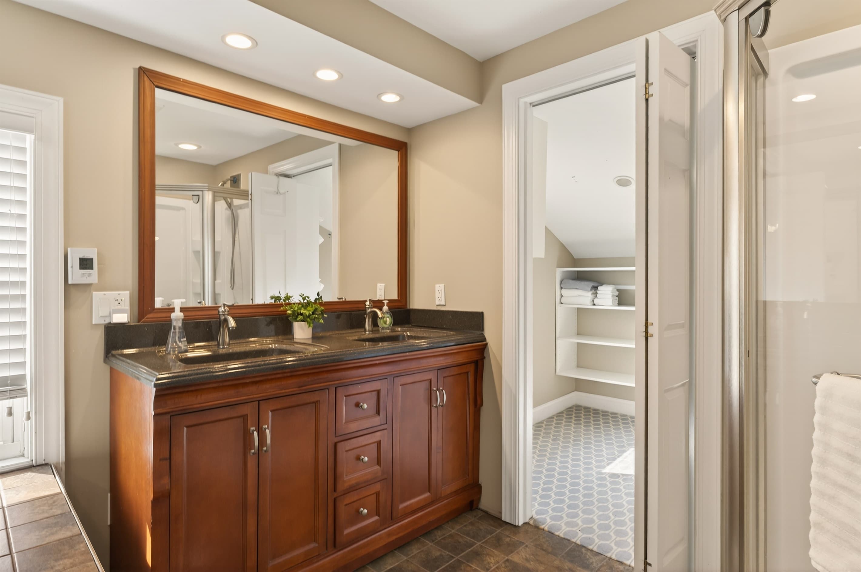Wooden vanity beside the glass shower