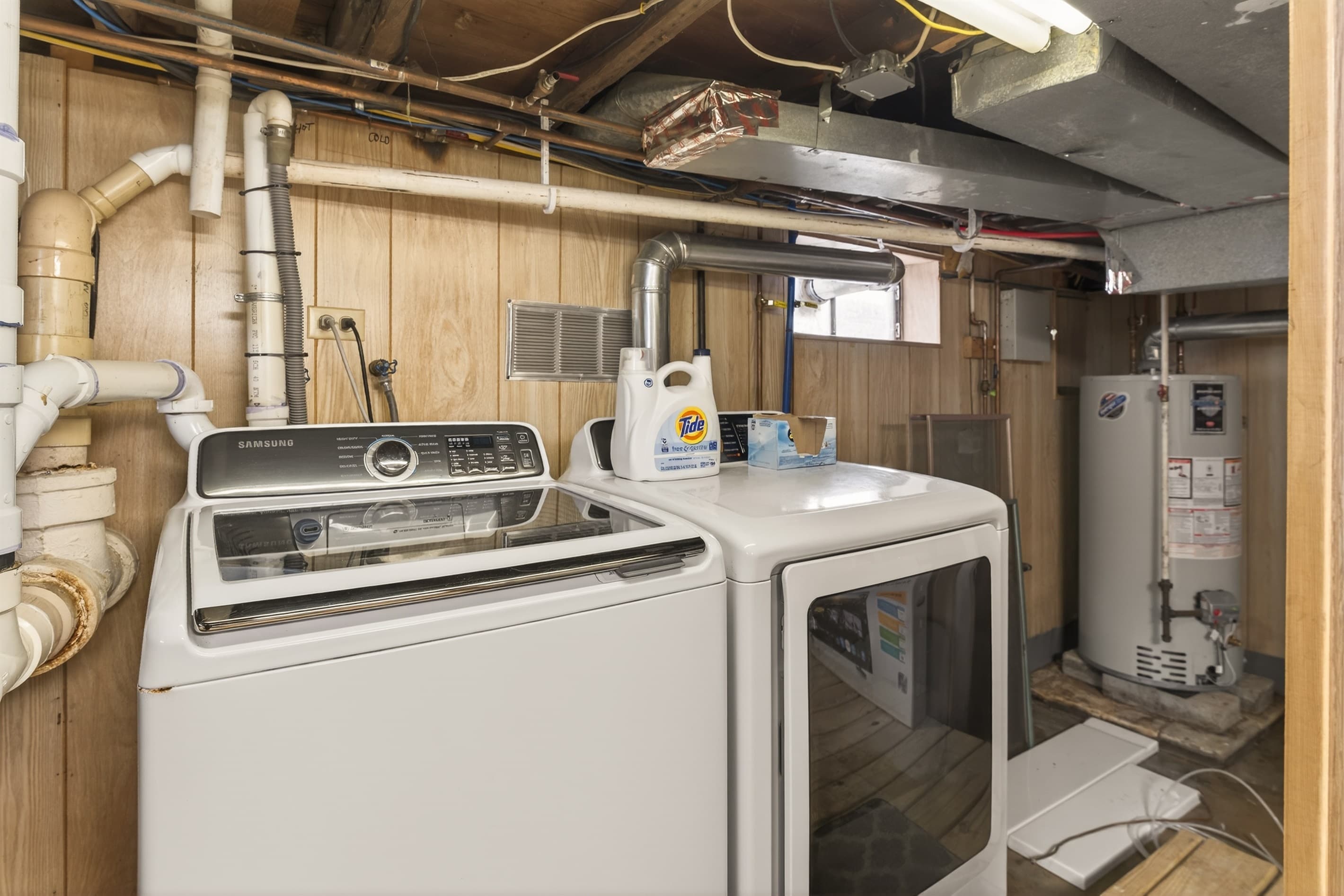 Basement laundry area with washer and dryer