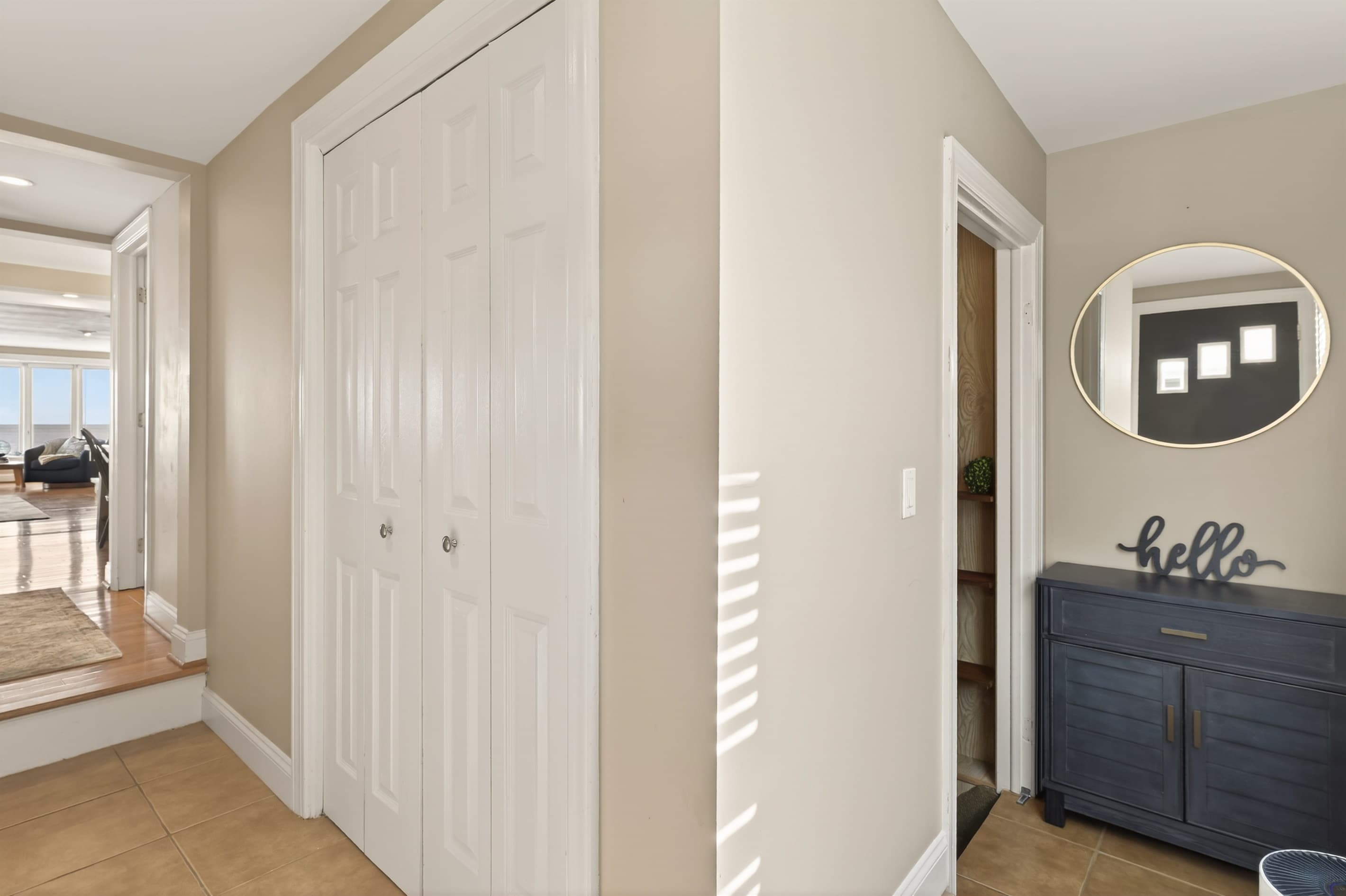 Hallway with closet doors and storage cabinet