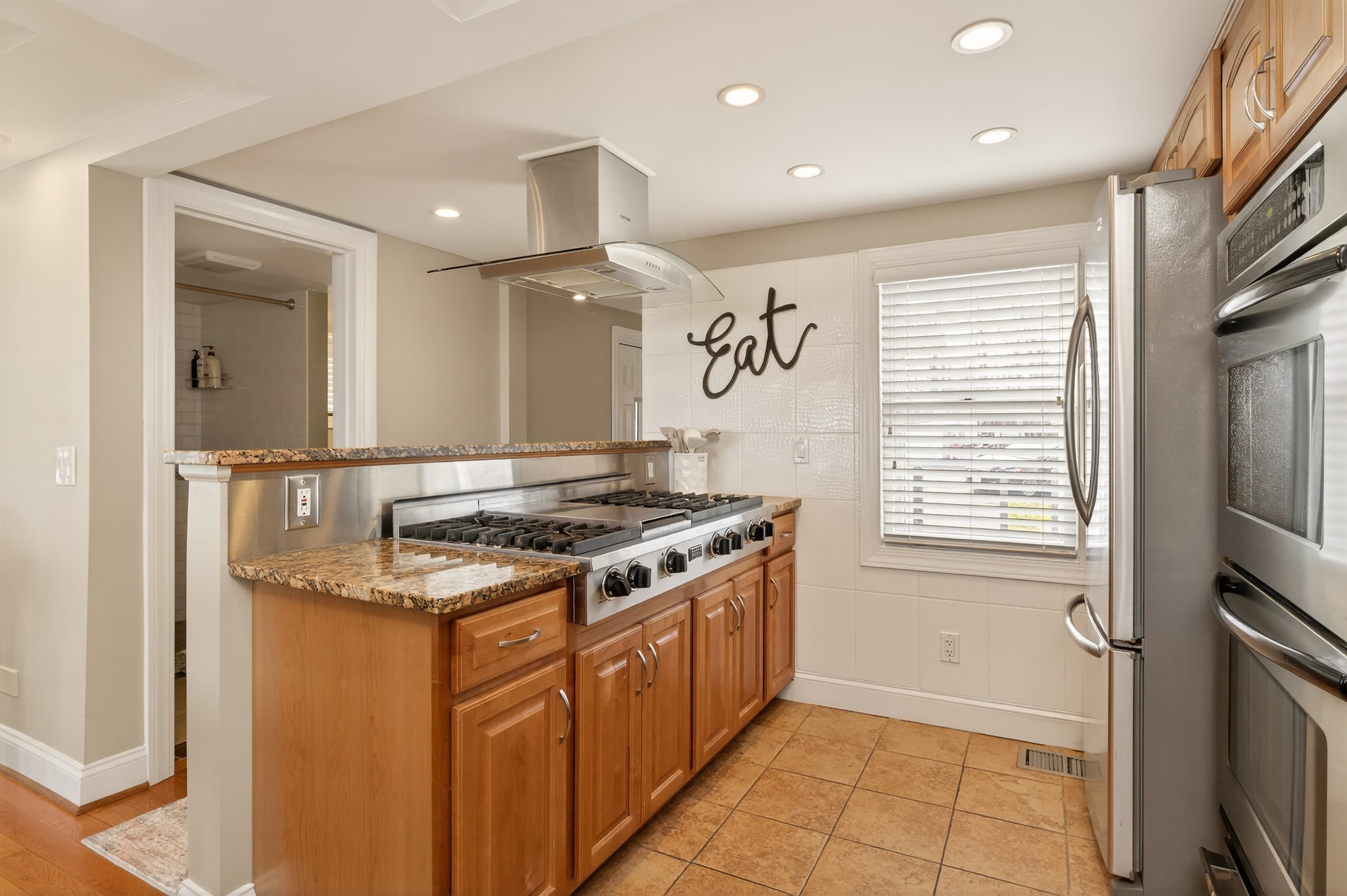 Kitchen with range, microwave, and refrigerator