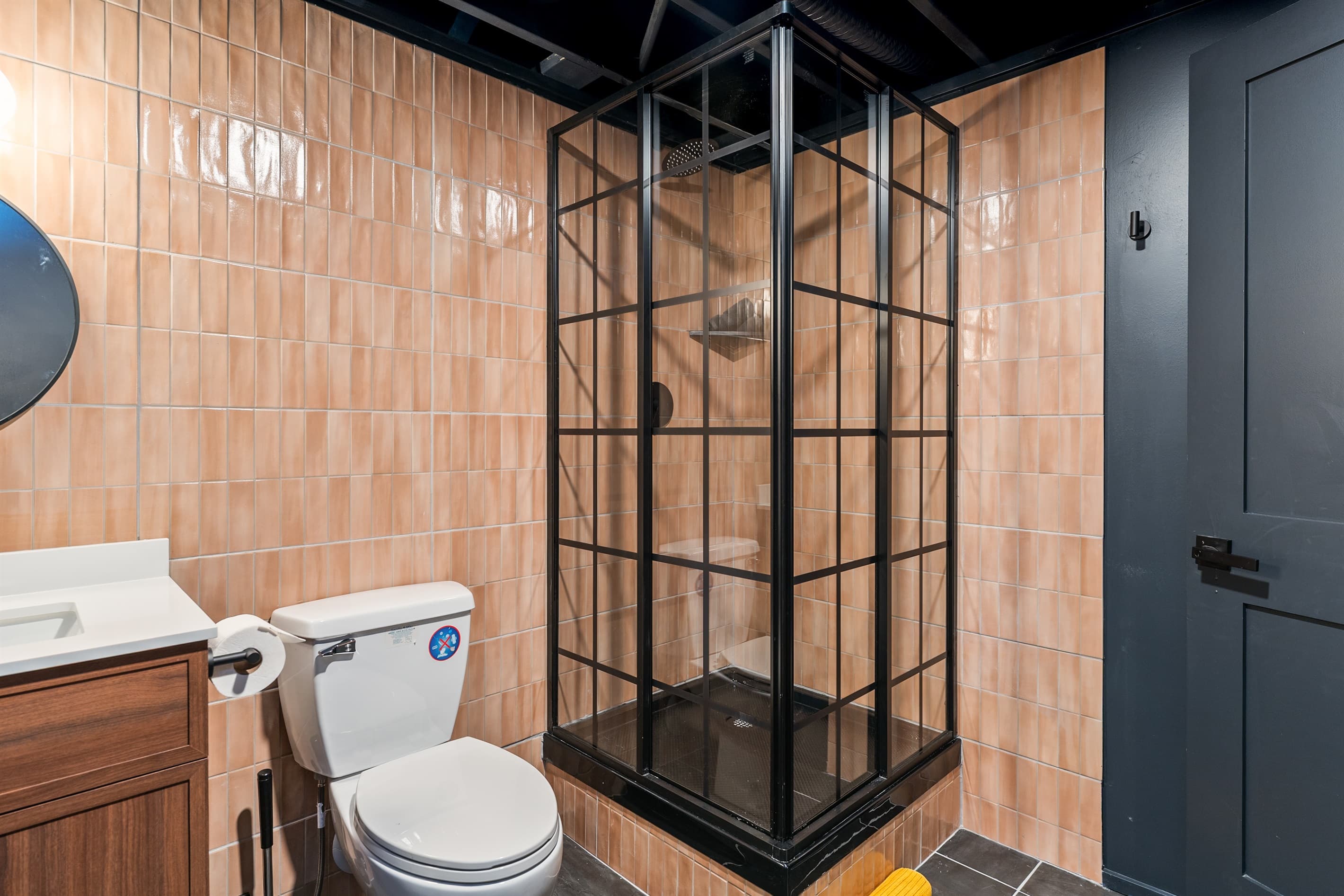 Walk-in shower with black-framed glass enclosure
