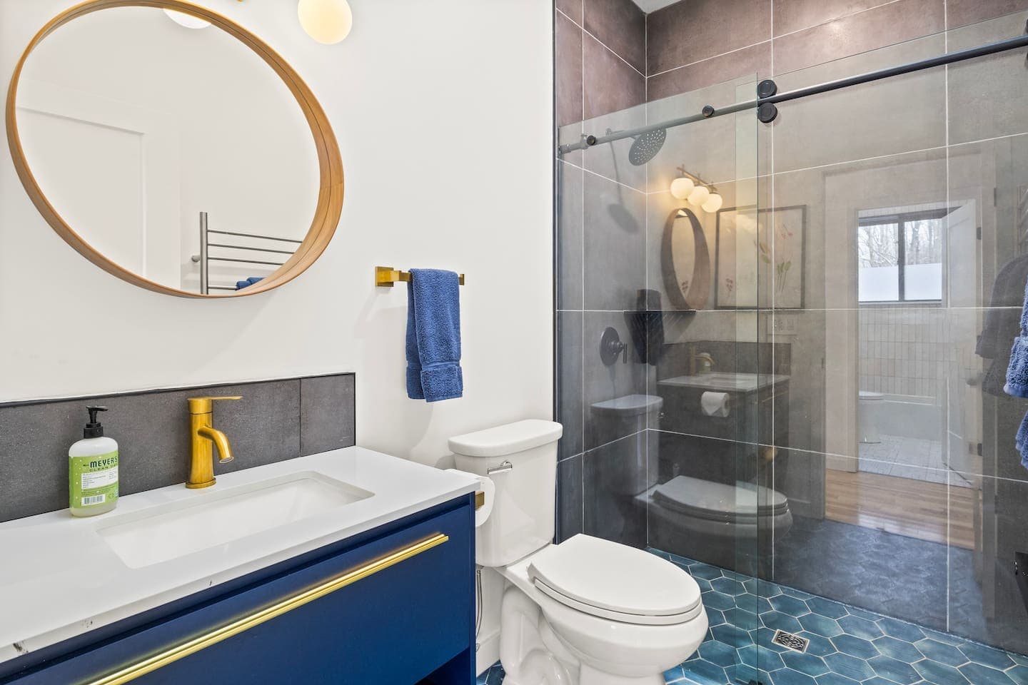 Bathroom vanity beside glass-enclosed shower