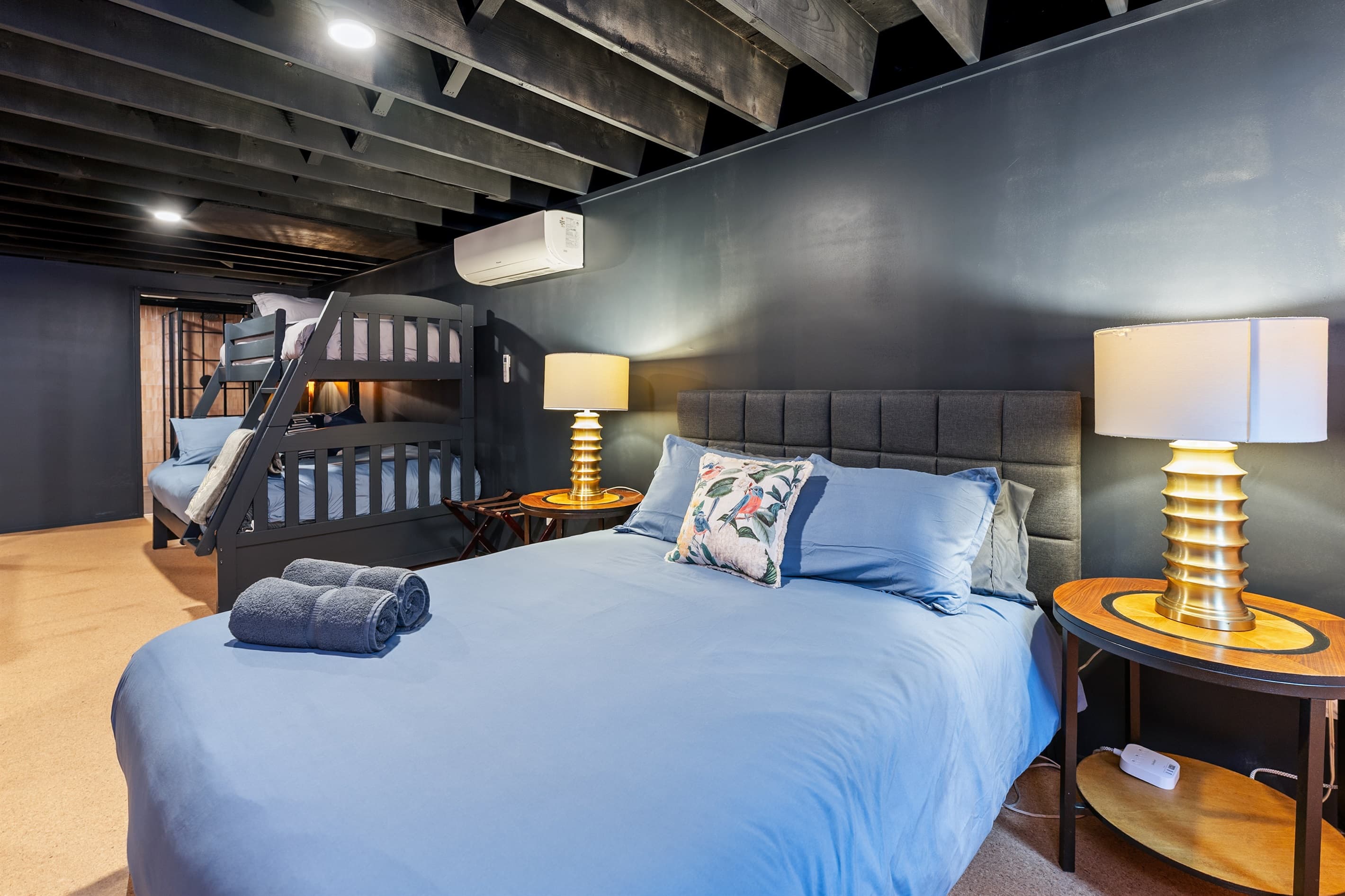 Lower-level bedroom with bedside lighting