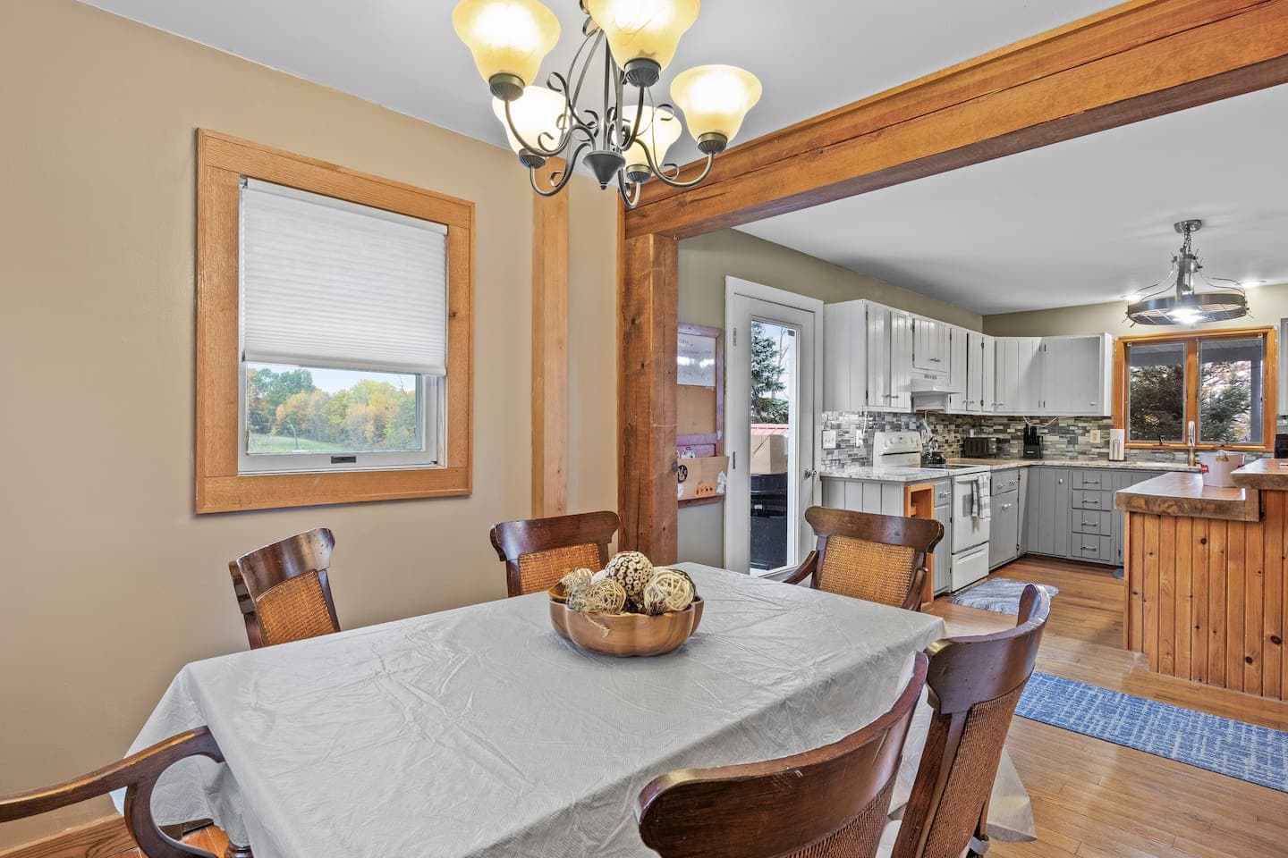Dining table beneath a glass chandelier