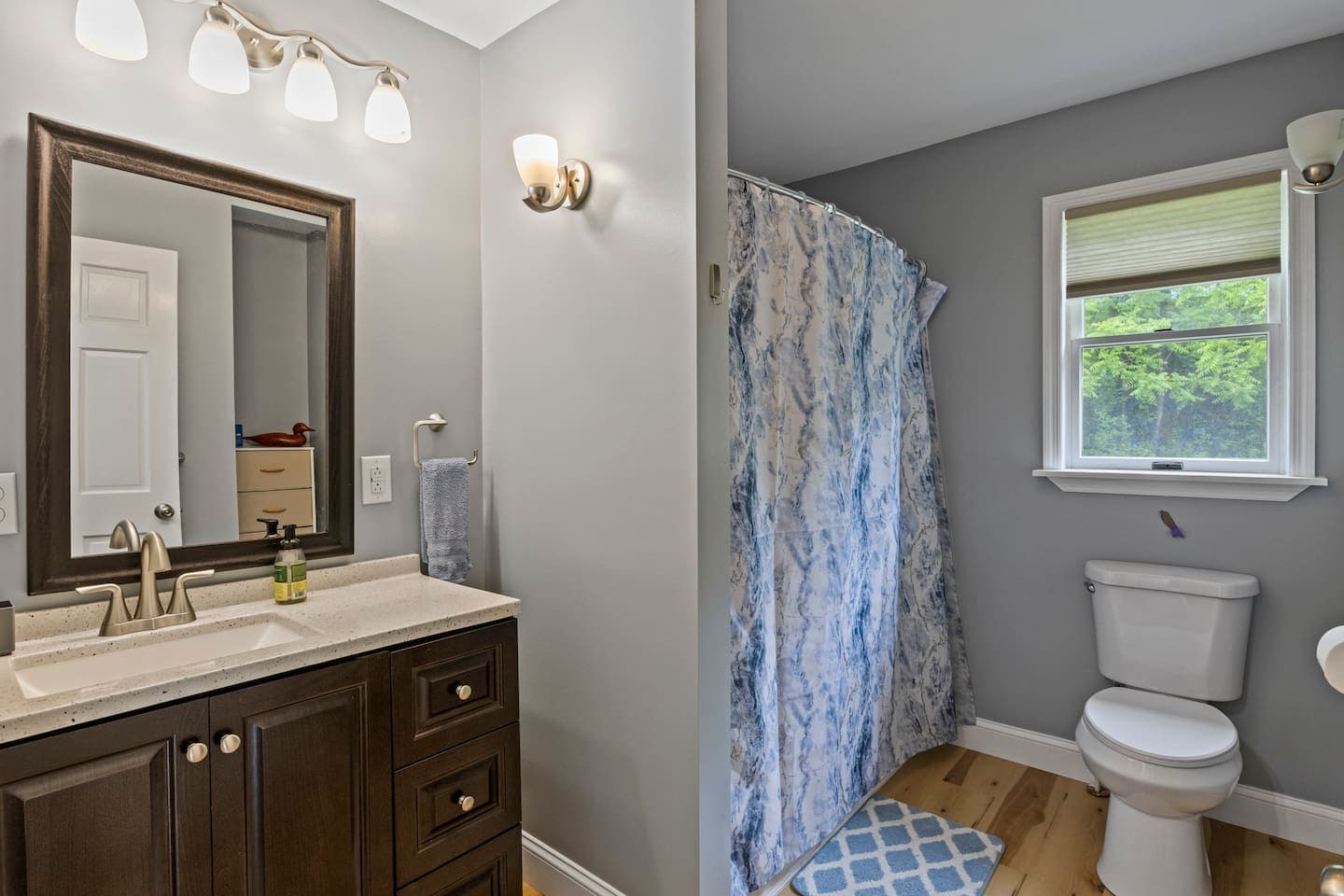 
Bathroom with vanity, toilet, and shower curtain