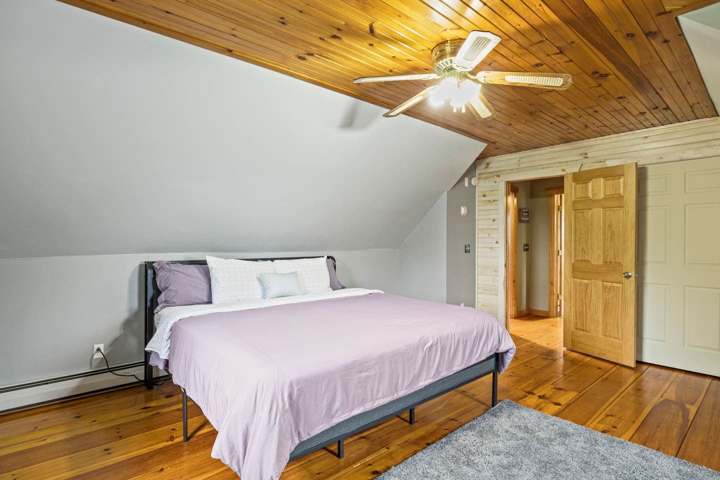Large bed beside the wooden closet