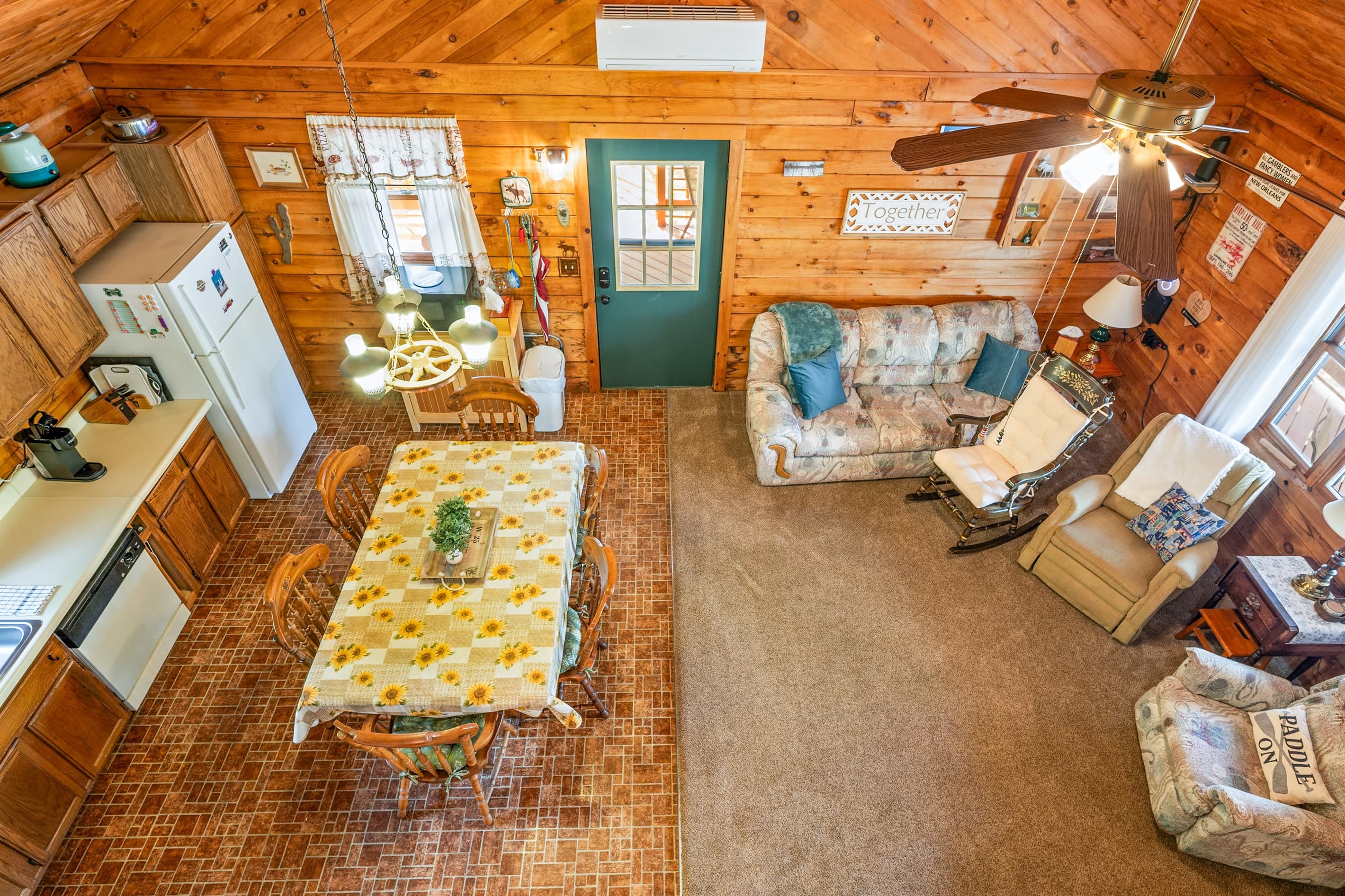 Farmhouse table within wood-paneled kitchen