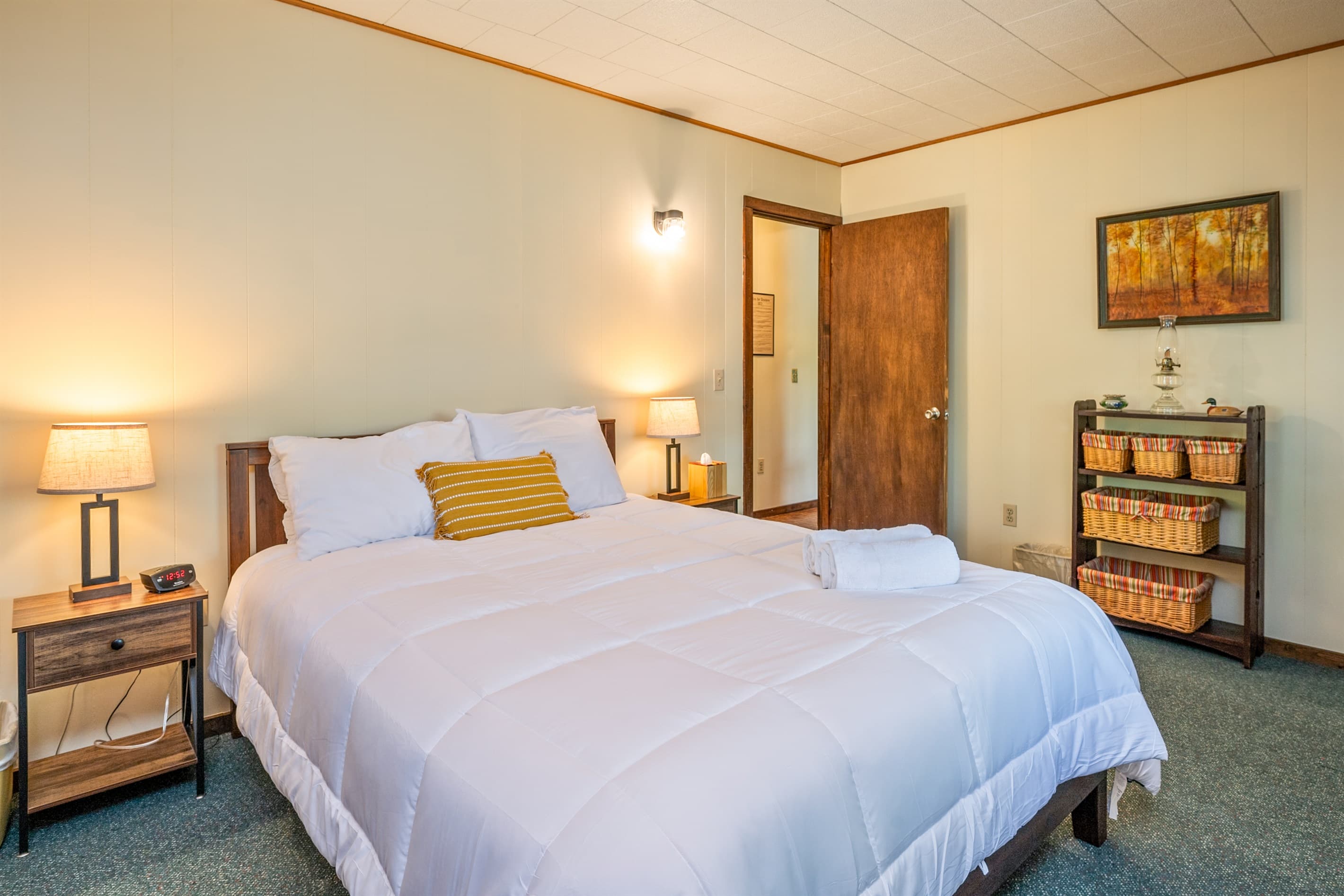 Bedroom with wooden nightstand and door 