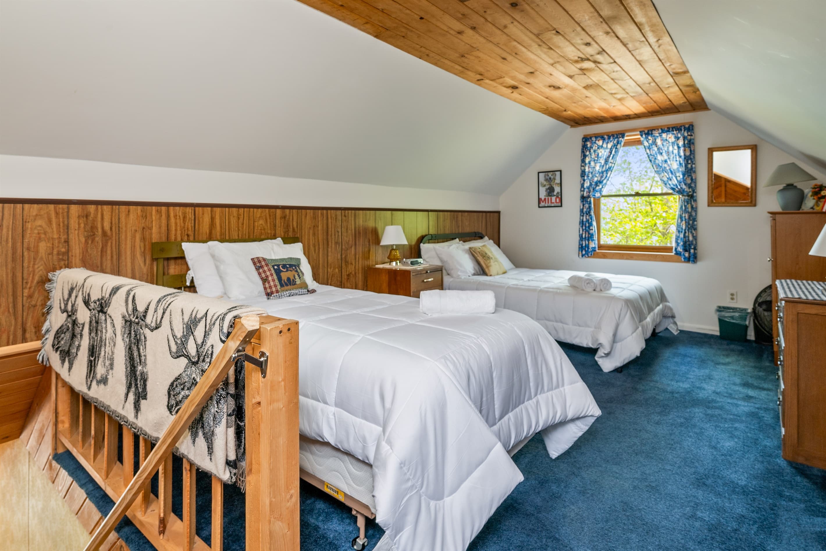 Two beds beneath sloped ceiling