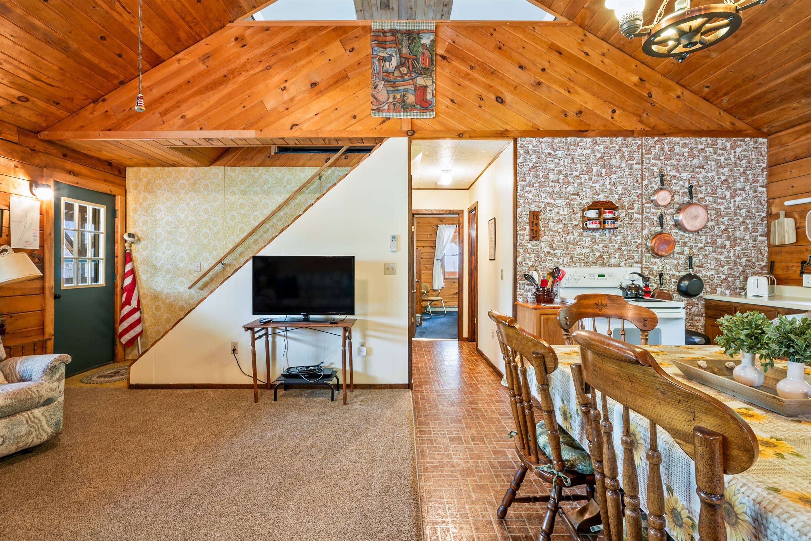 Living room beneath vaulted wood ceiling