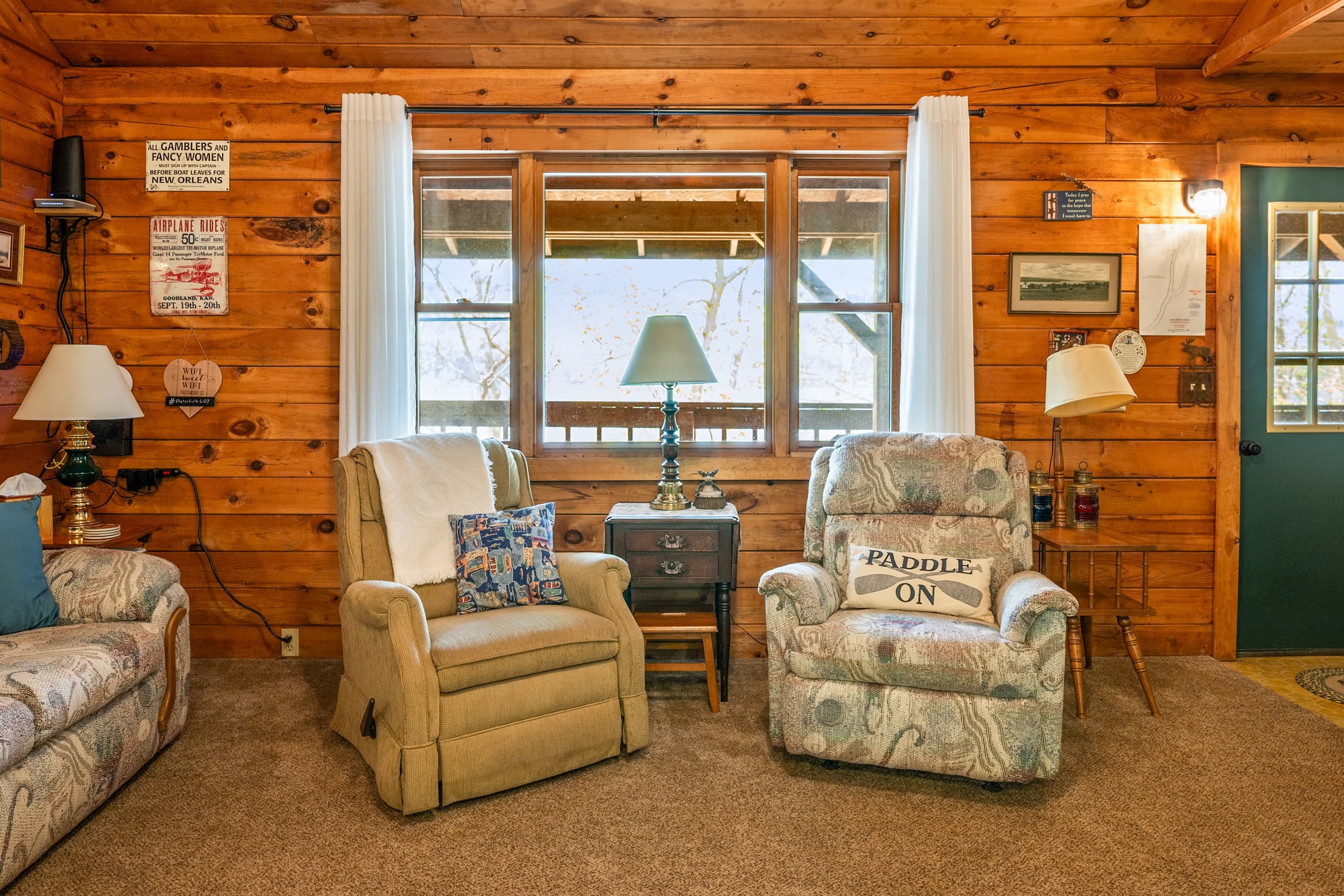 Armchairs positioned beside large windows