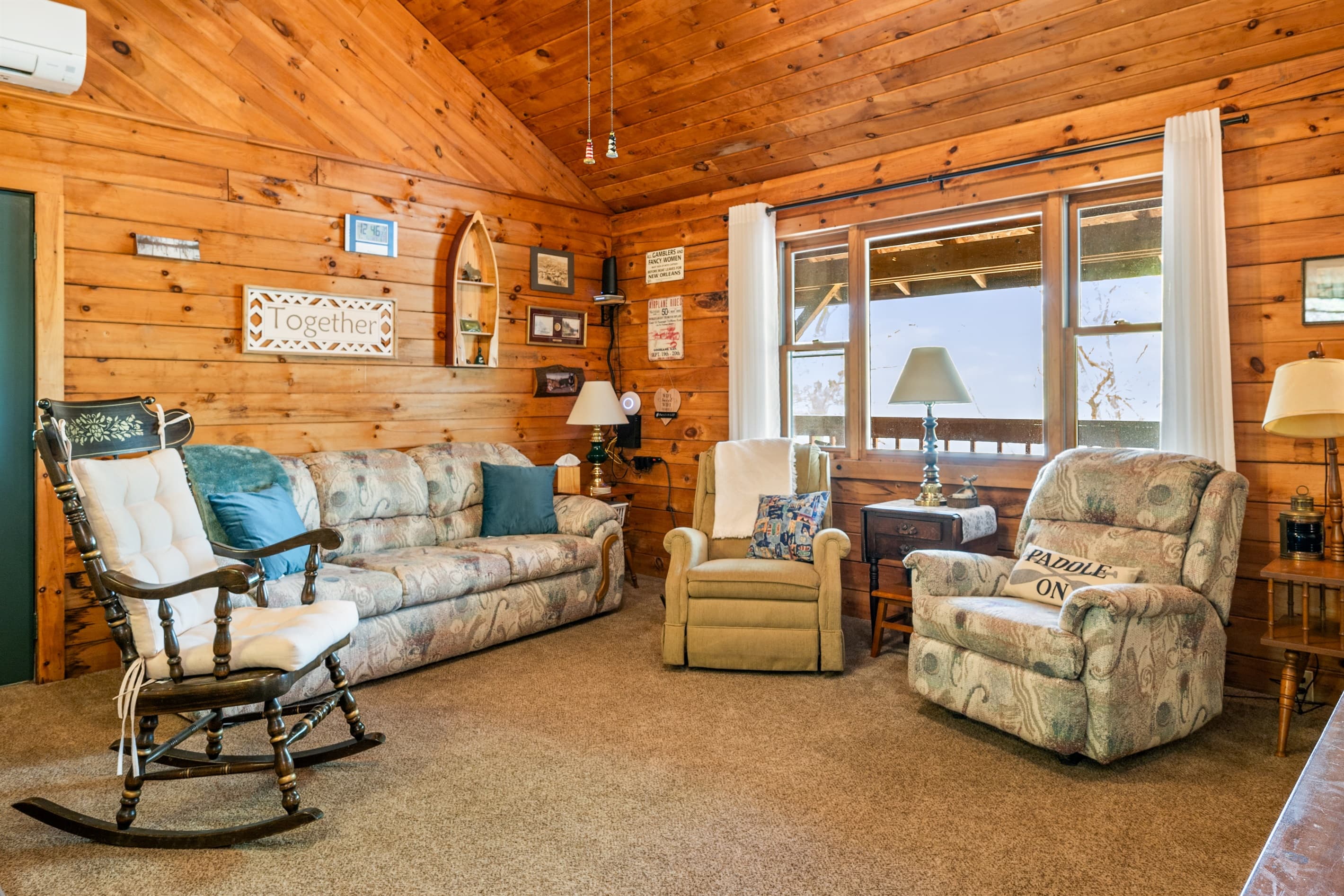 Sofa seating within wood-paneled living area