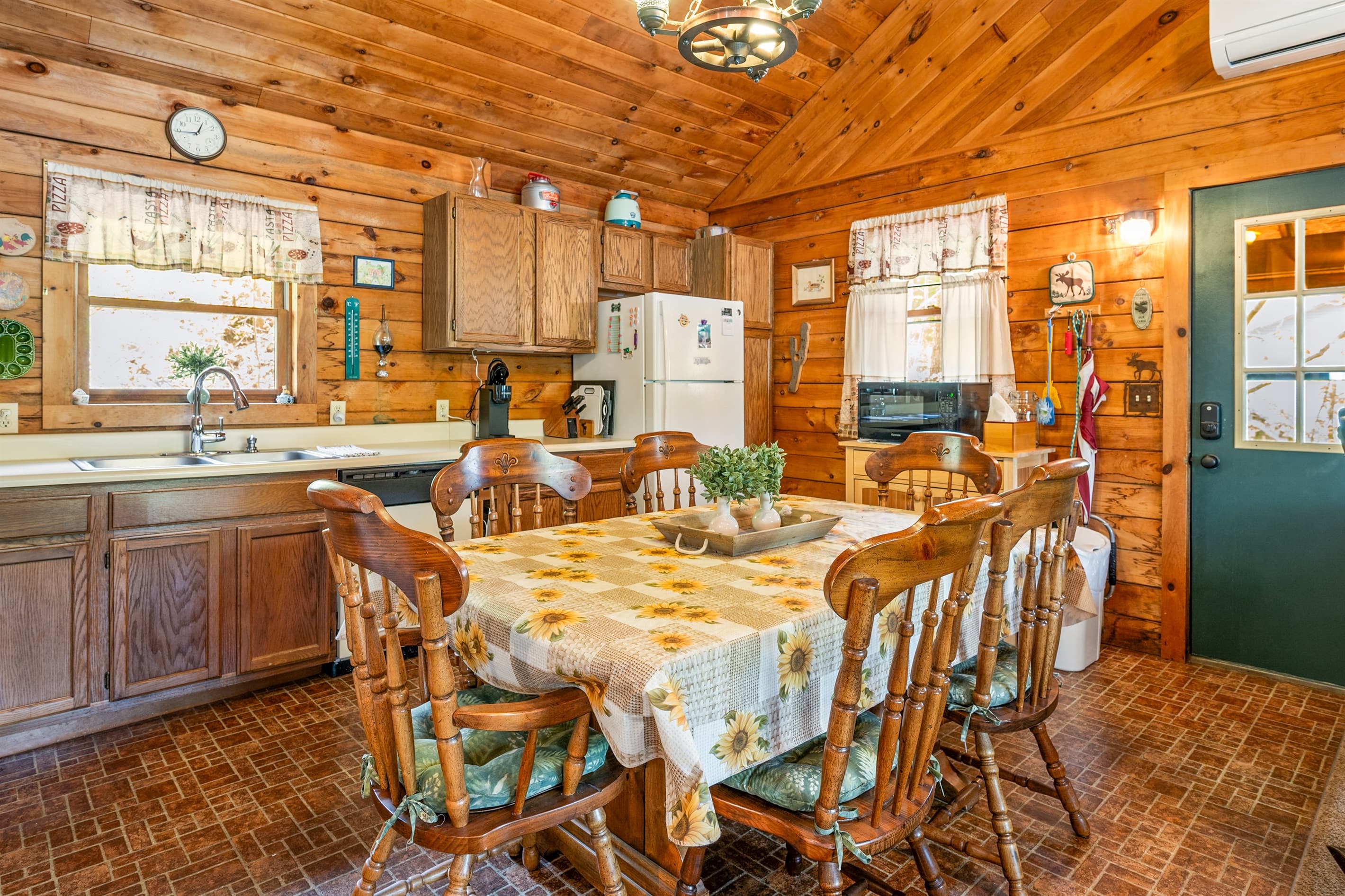 Dining table beside wooden kitchen cabinetry