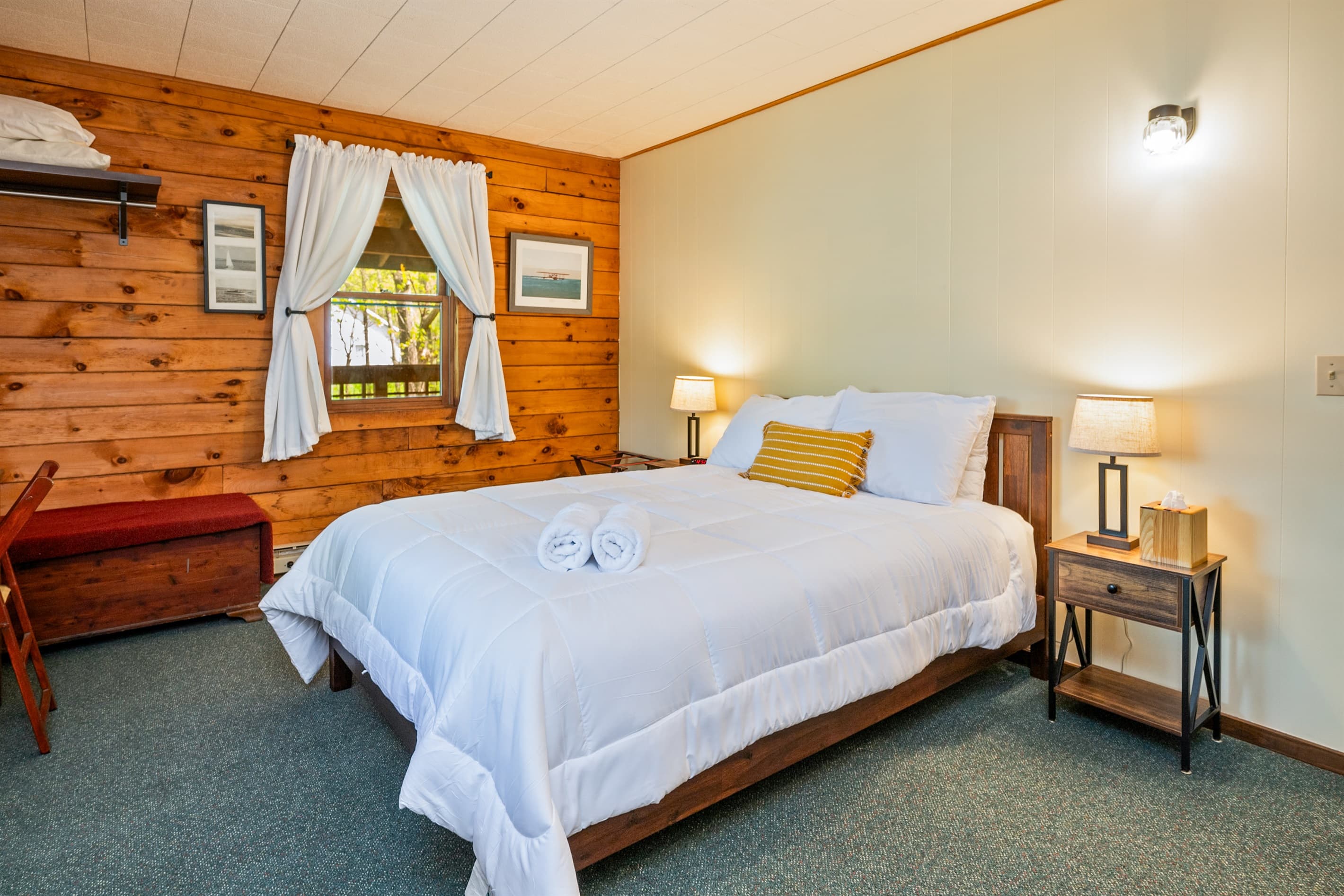 Bed beside window and wooden nightstand