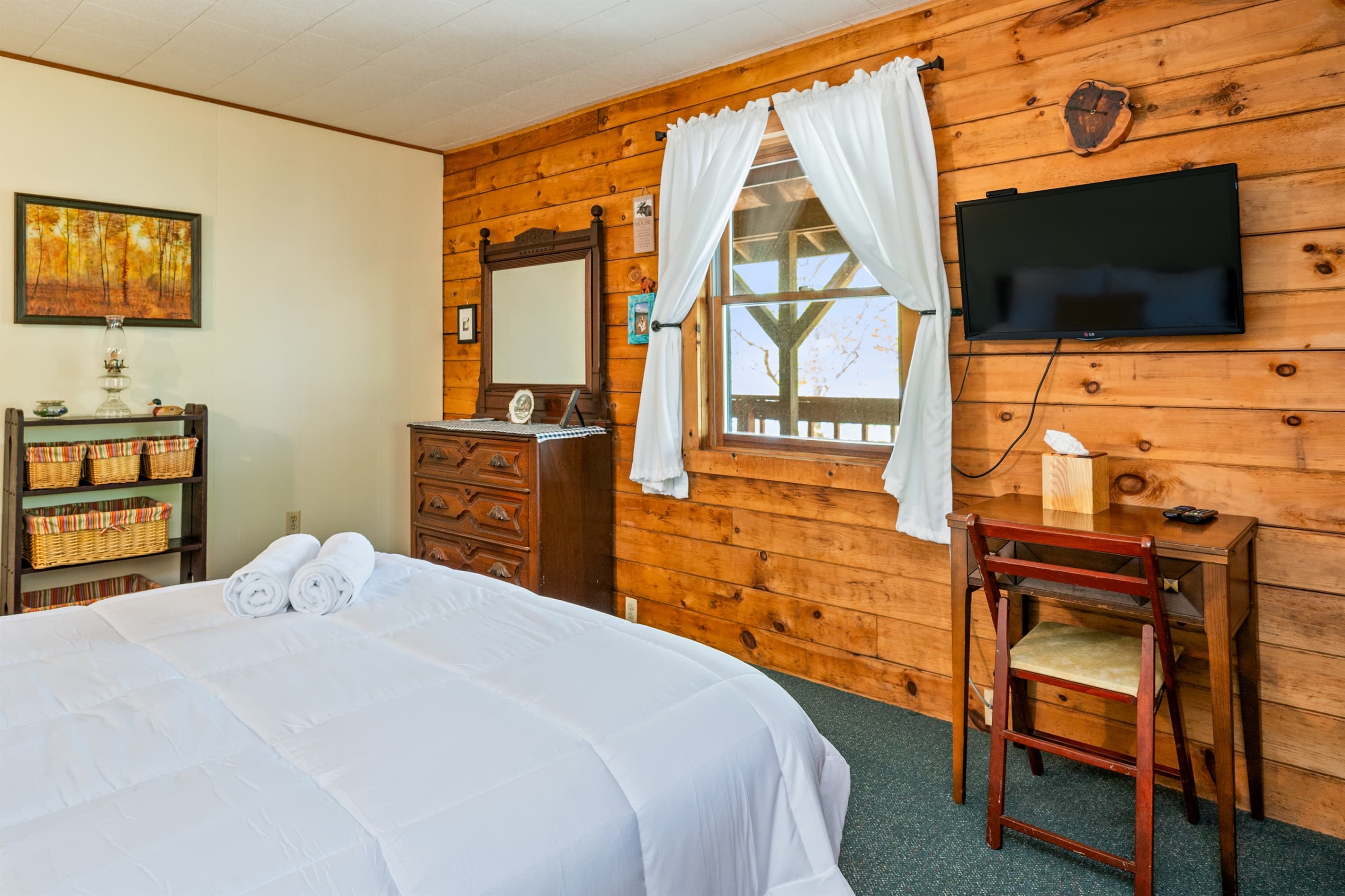 Bedroom television beside curtained window