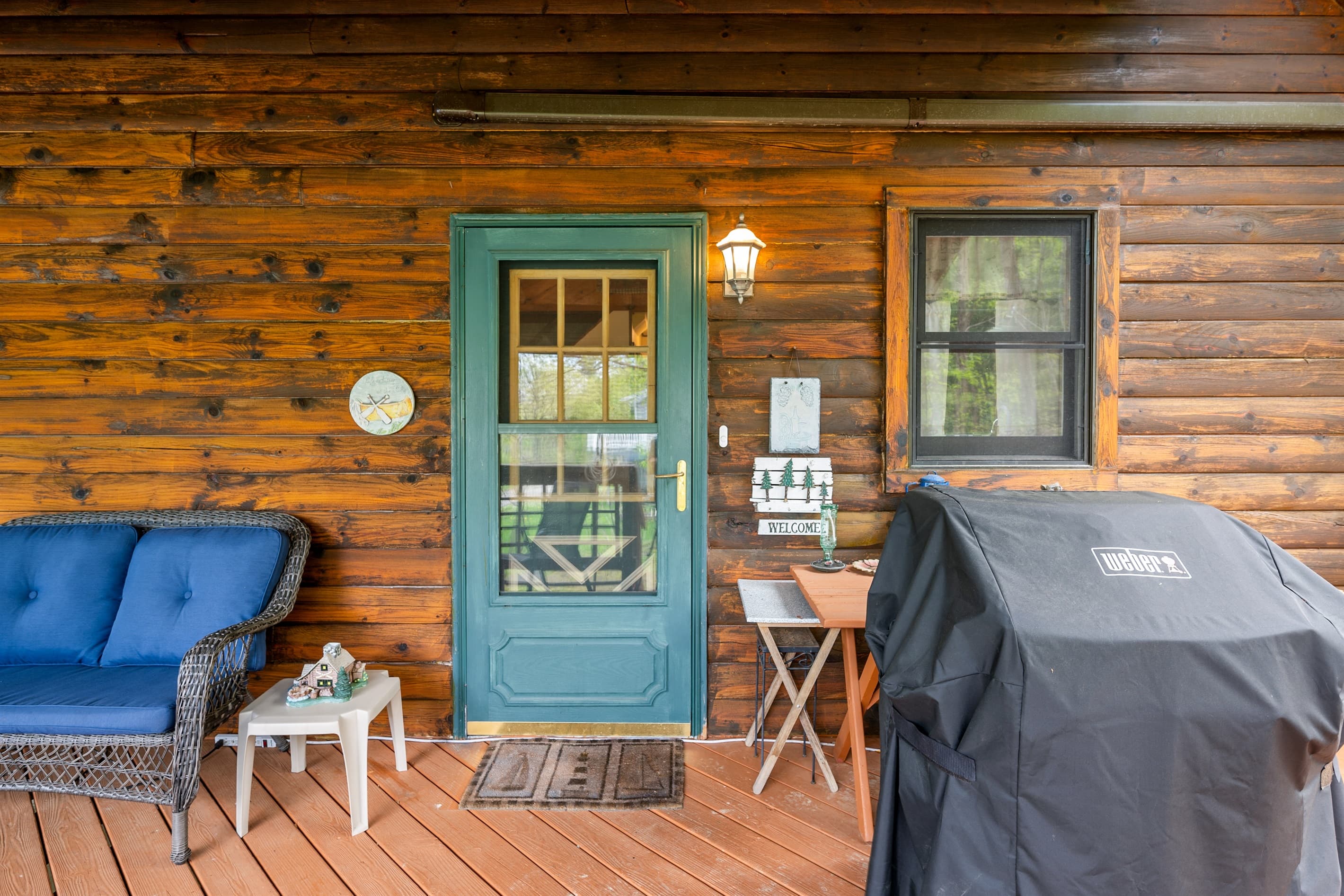 Covered porch with seating beside green door