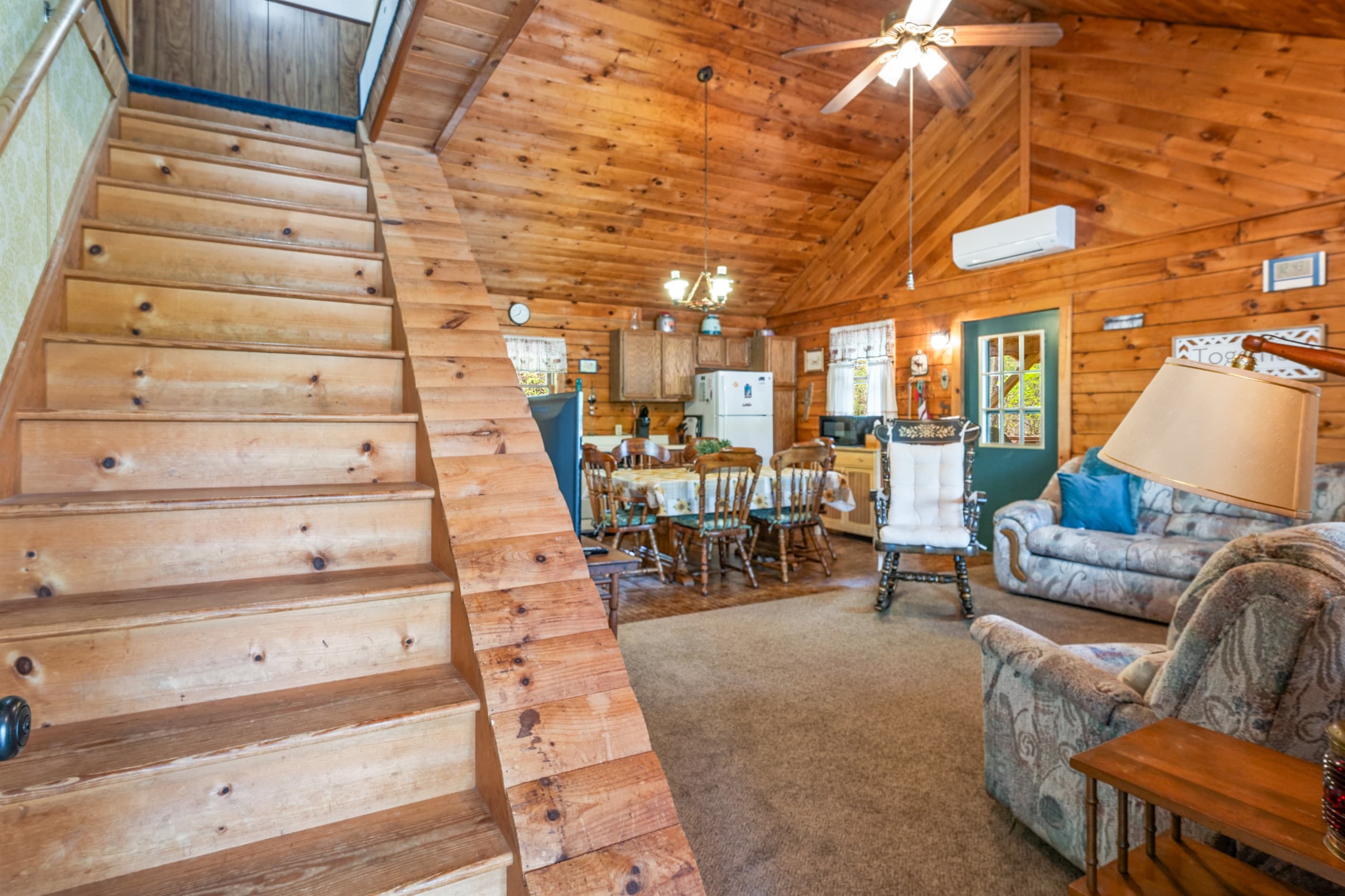 Vaulted staircase with wood-paneled walls