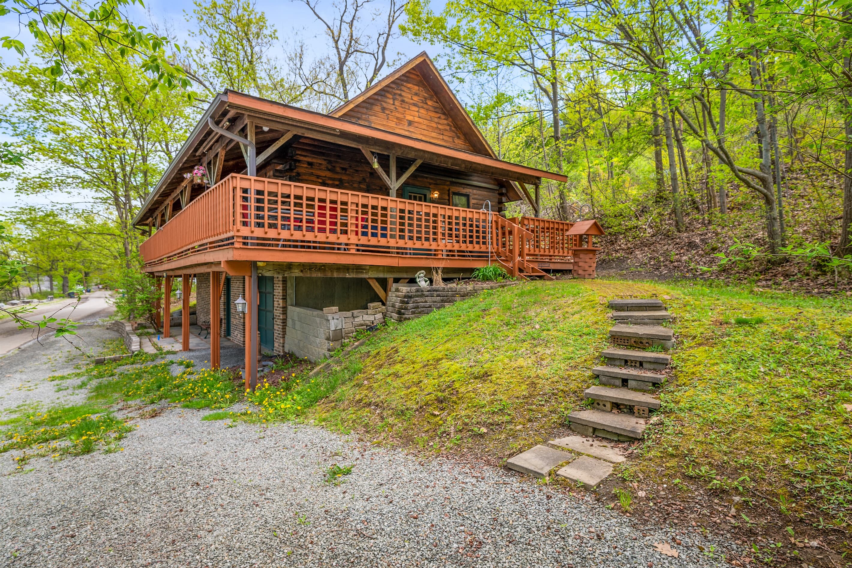 Log cabin surrounded by wooded grounds