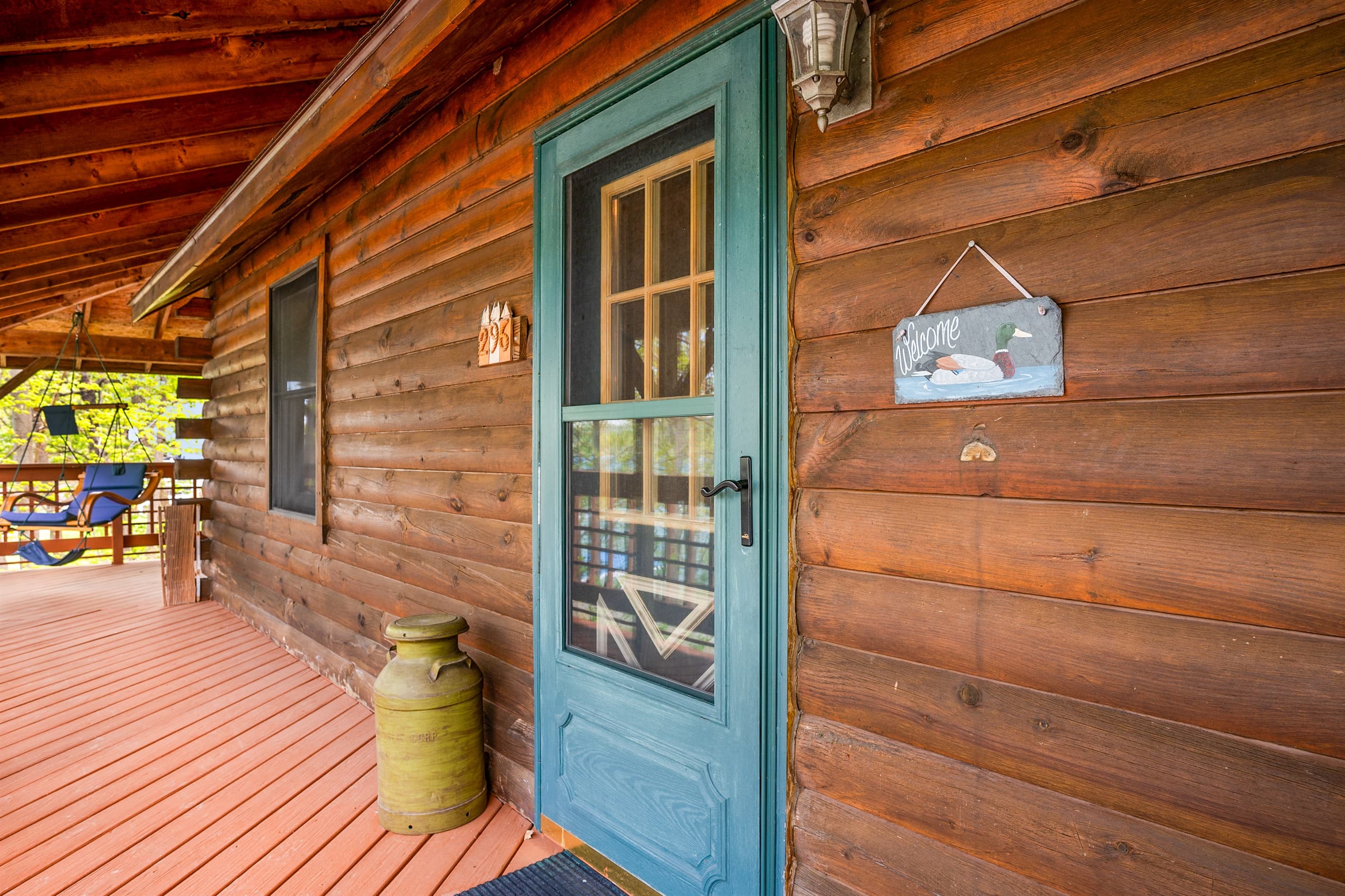 Green exterior door along covered porch