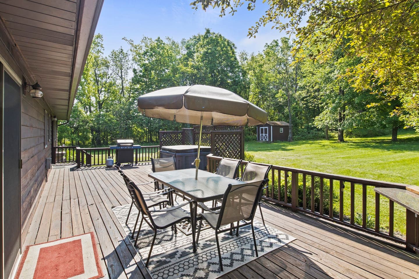 Wooden deck with dining table and umbrella