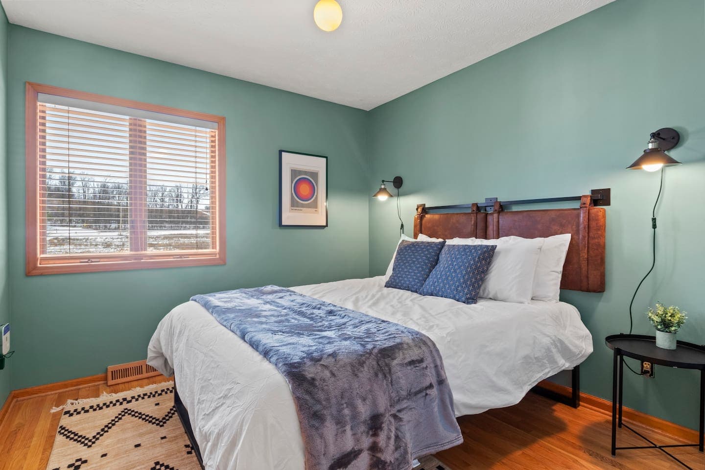 Teal bedroom with wall-mounted reading lamps
