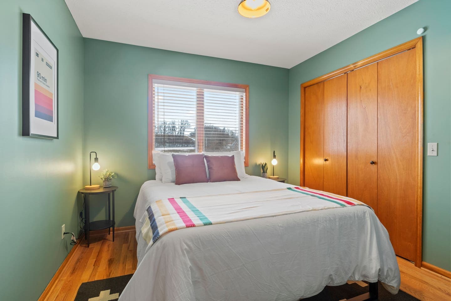 Teal bedroom with wooden closet doors