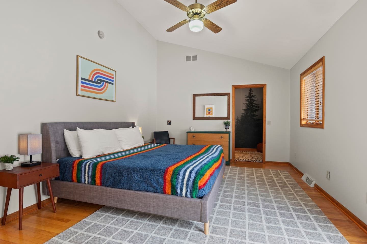 Bedroom with multicolored striped bedding