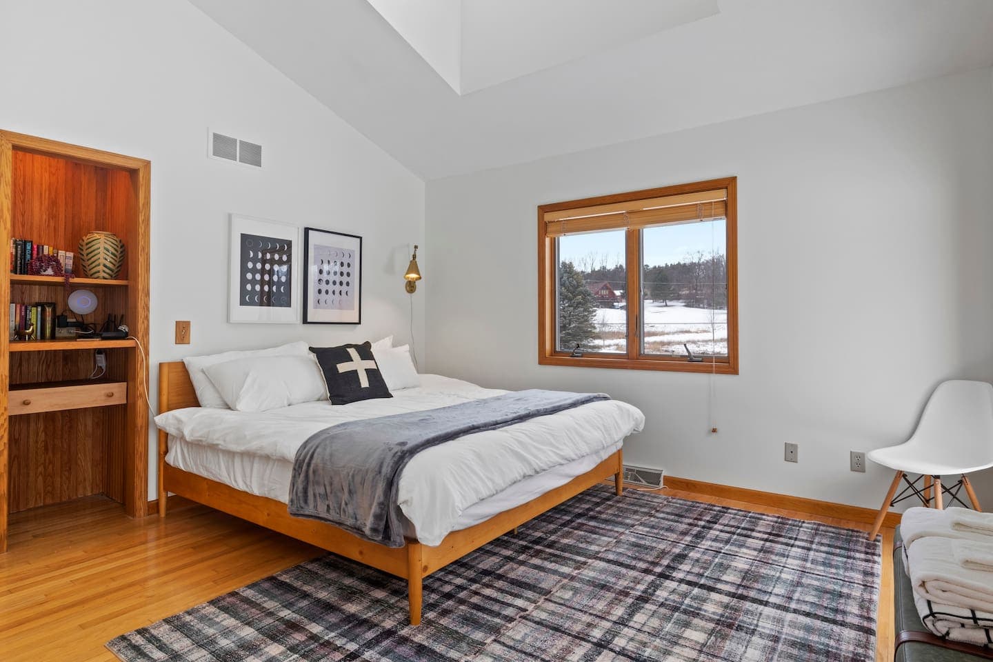 Bedroom with white bedding and built-in shelving