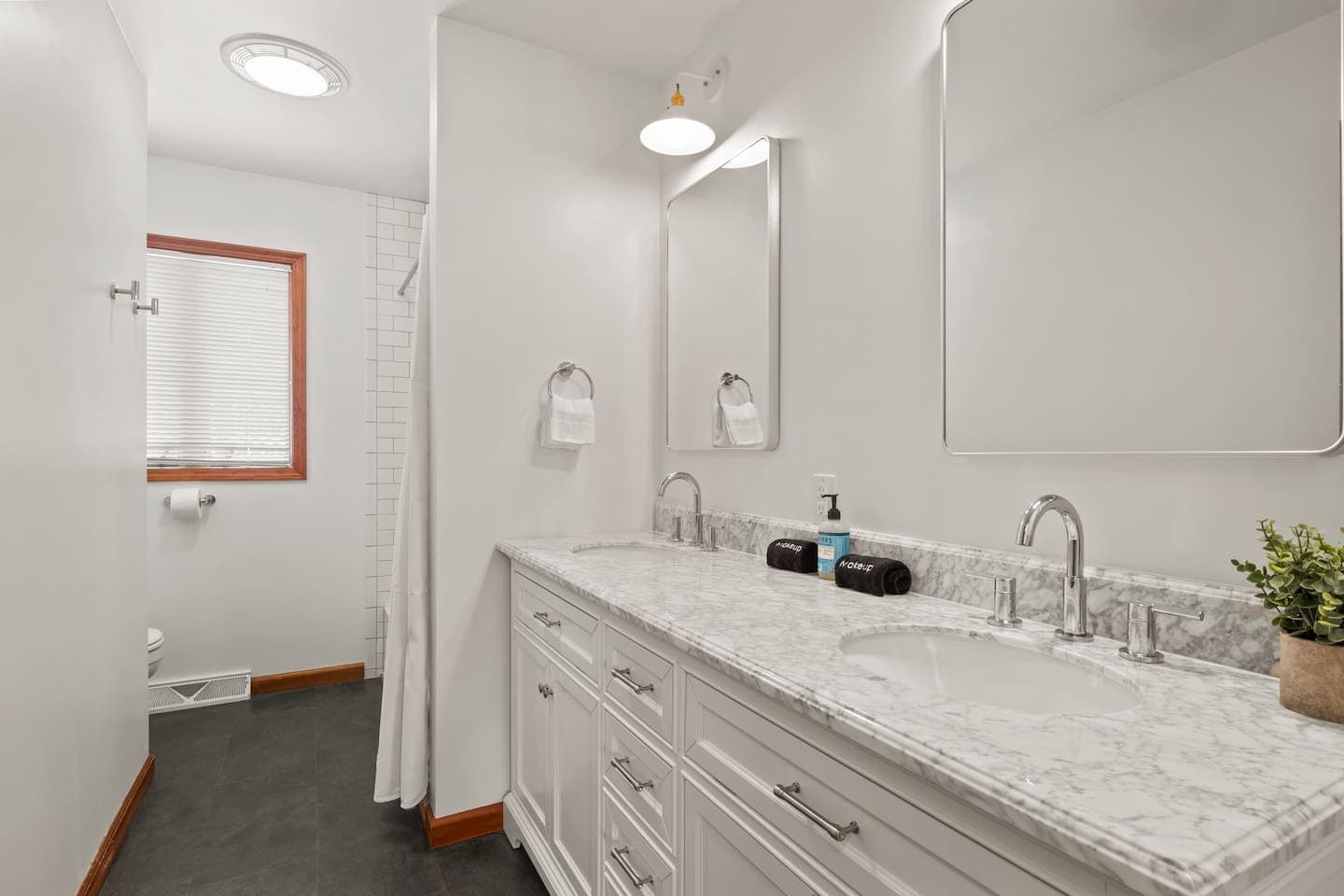 Bathroom with double vanity and shower