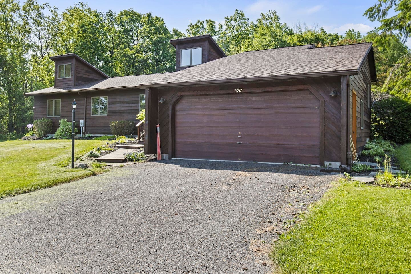 Attached garage beside the gravel driveway