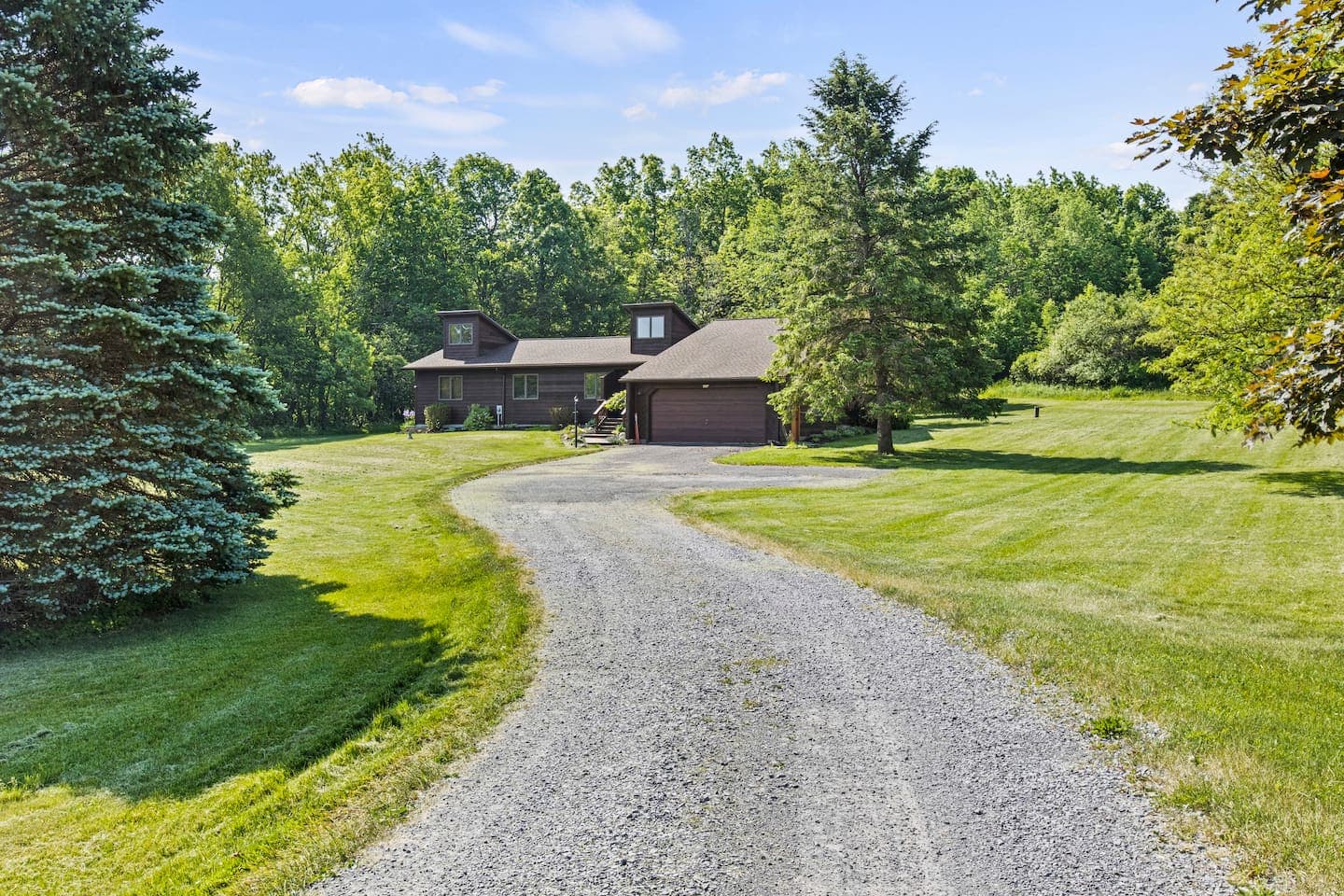 Curved gravel driveway leading to the home