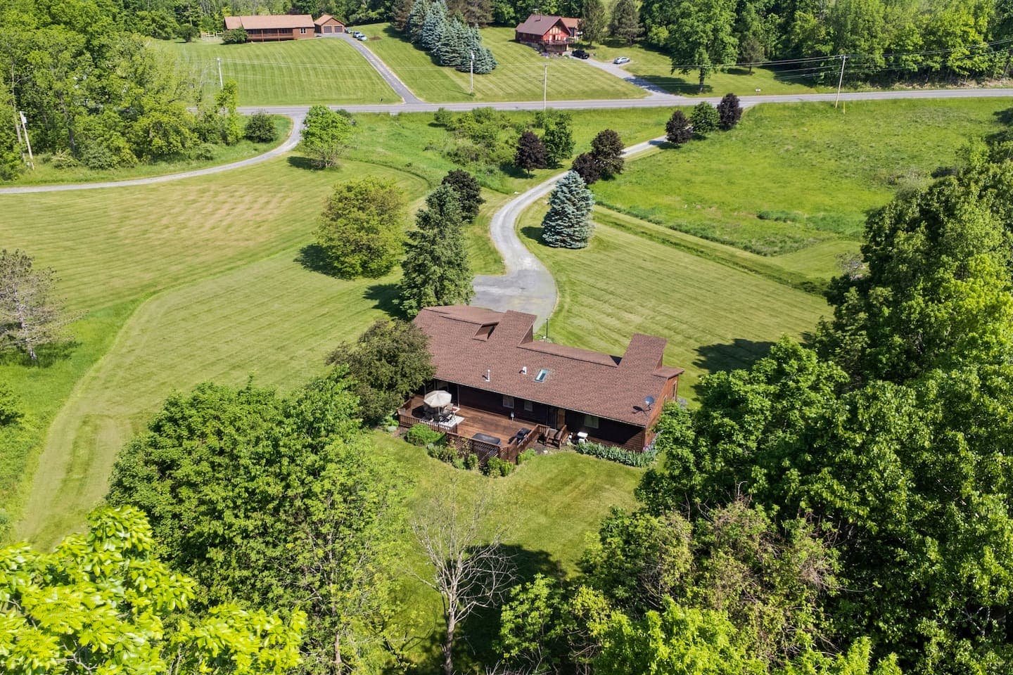 Aerial view of the home and winding driveway