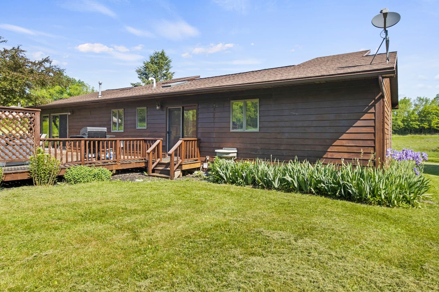 Side exterior with wooden deck and steps