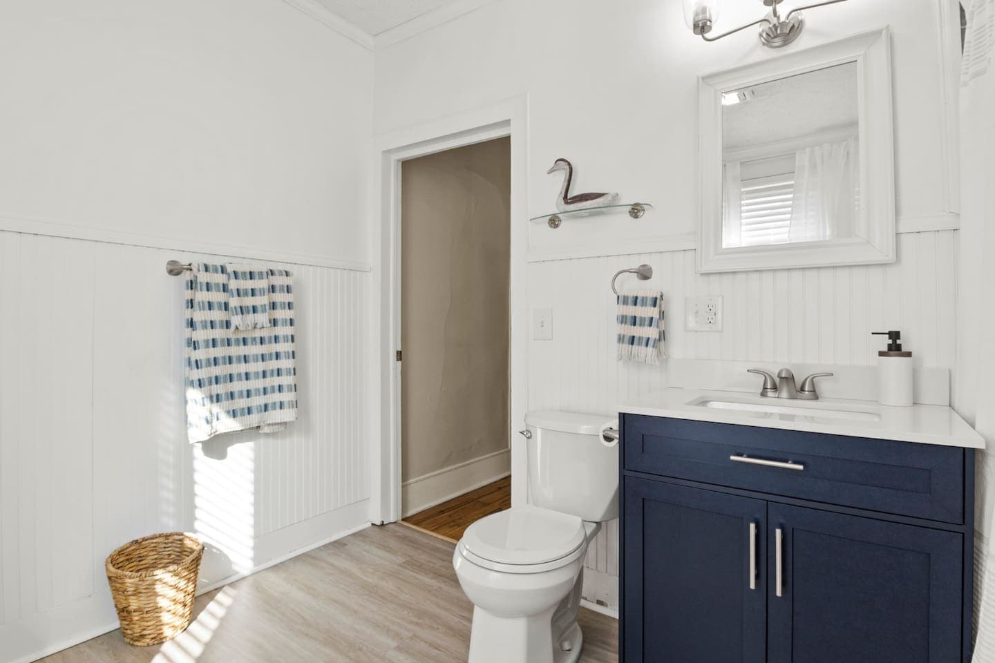 Bathroom with blue vanity and toilet