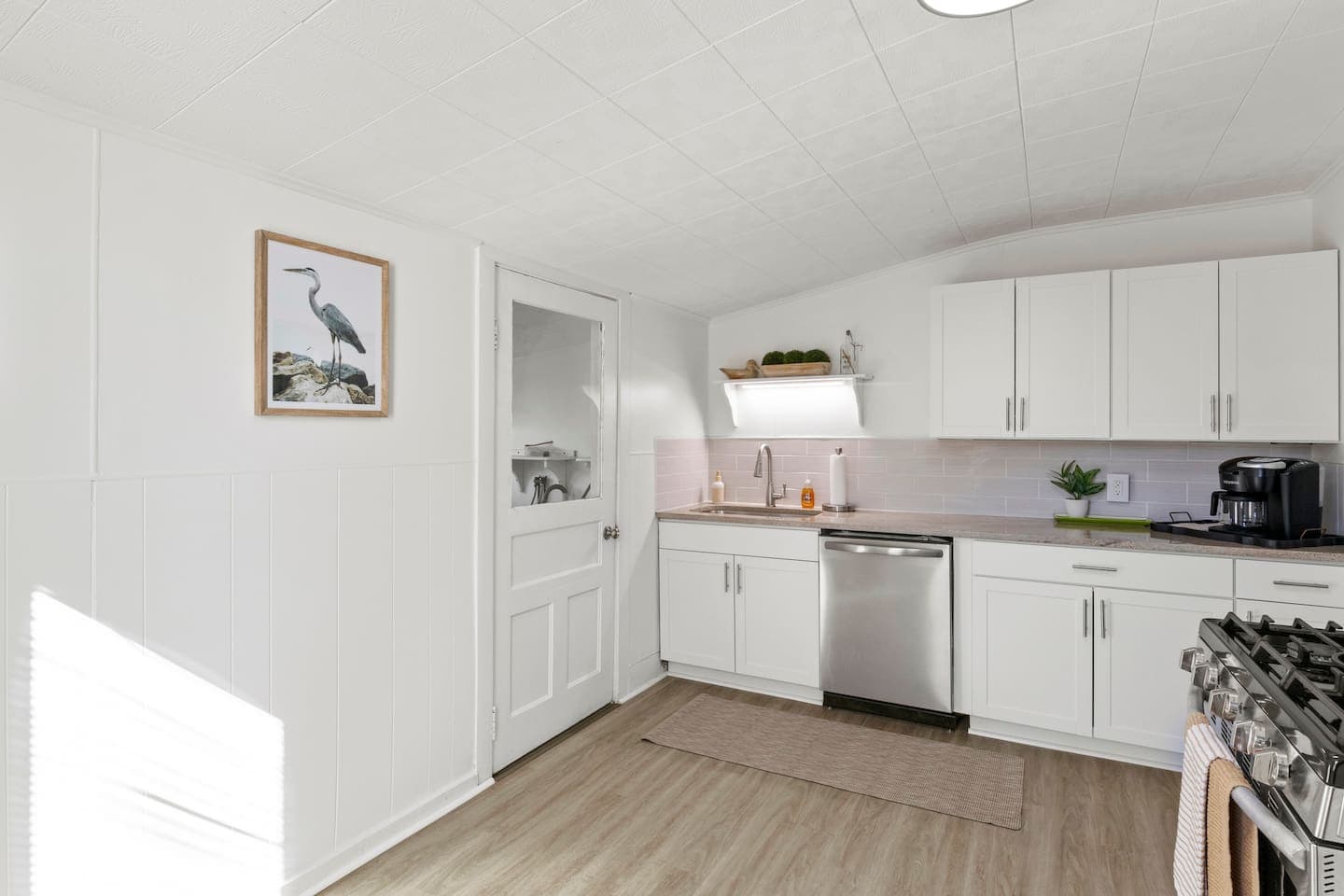 Full kitchen with white cabinetry